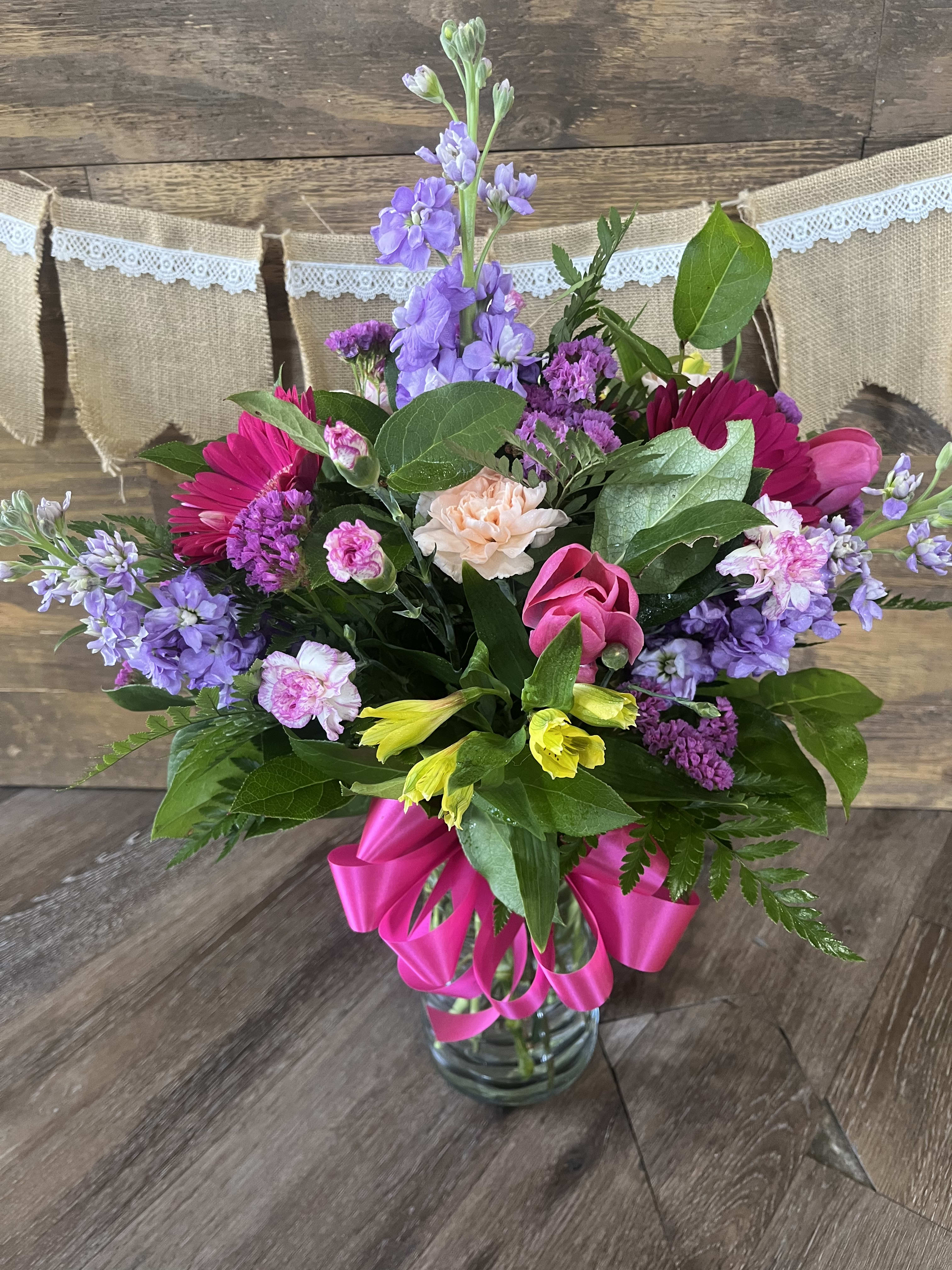 Make Her Day - This beautiful and bright arrangement is filled with fragrant Stock, beautiful Gerbera Daisies, and much more!