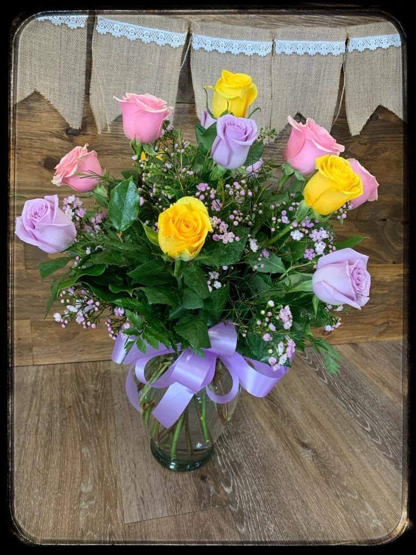 Spring Day - This bright, cheery and fun mix of roses is sure to put a smile on someone's face! This mix of yellow, purple and pink roses is the perfect way to show someone you care! 