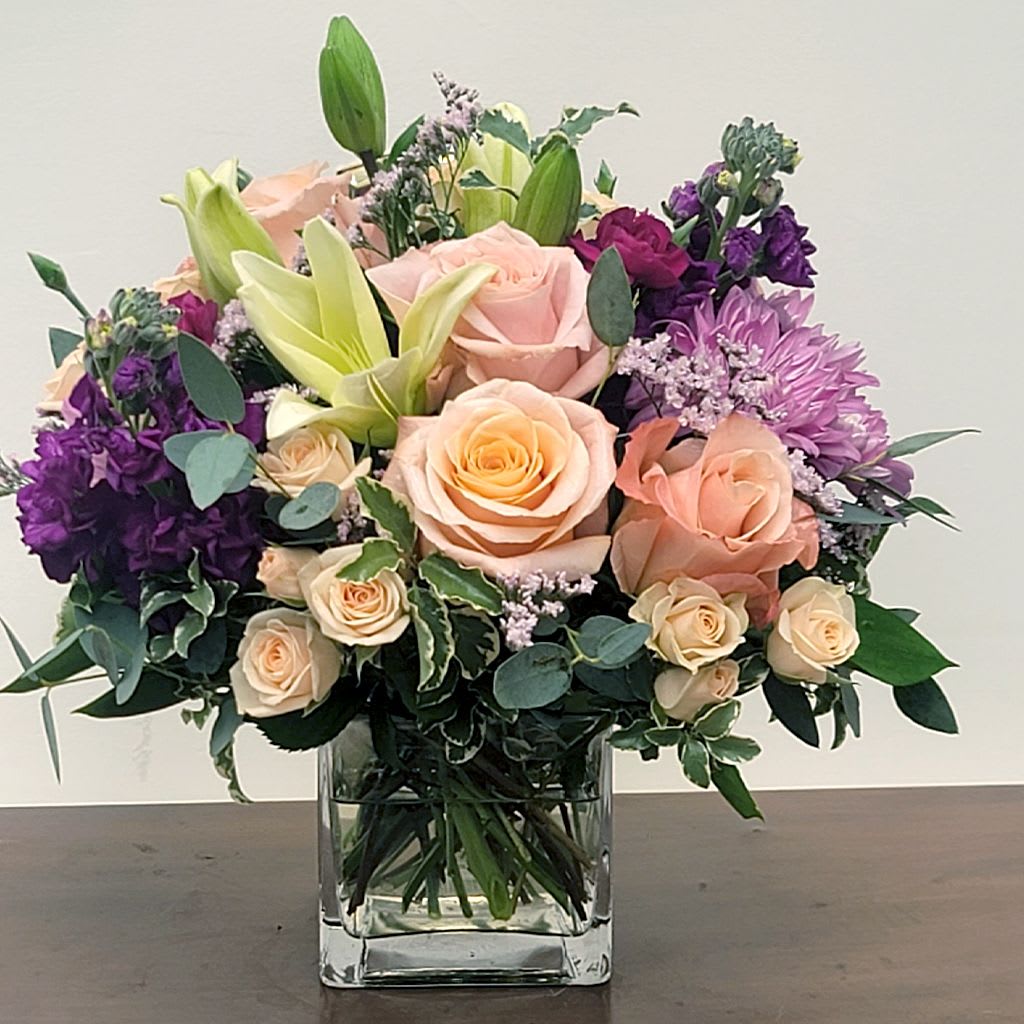 Mani-Pedit Bouquet - As soothing as a day of self-care, this dazzling bouquet of soft hues of roses, lilies, alstroemeria, chrysanthemums, and eucalyptus will leave your recipient feeling refreshed!  It's that bouquet that can never go wrong for any occasion, whether it be birthdays, anniversaries, Mother's Day and just about any other moments.  Approximate Size: 11&quot; H x 9&quot; W. Square vase 5x5. Order now for a thoughtful, fresh gift! 