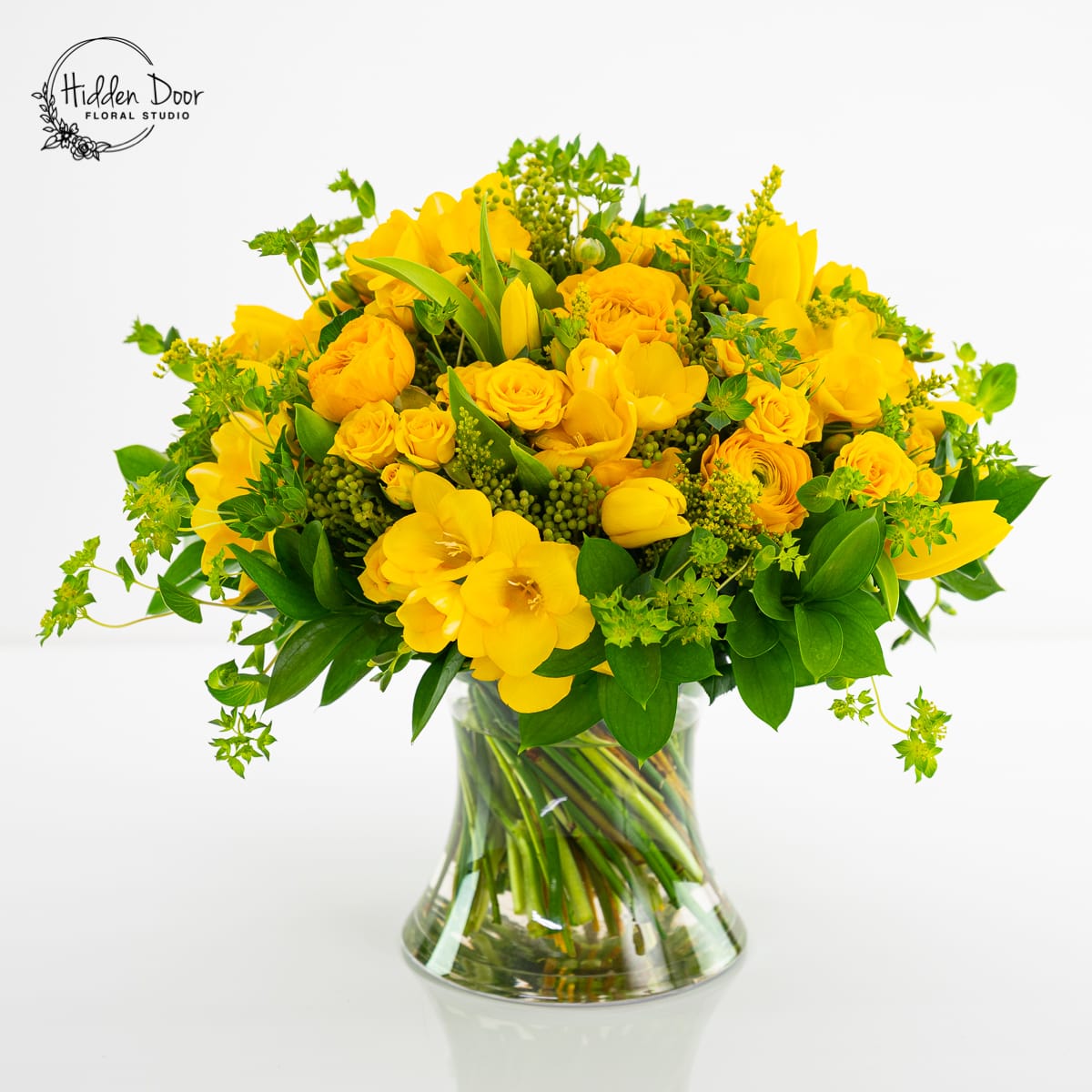 Gold Rush - Beautiful yellow floral arrangement with ranunculus, spray roses, freesias, and tulips. We will probably have to substitute some flowers but keep the color scheme.  * Photo Props are not part of the arrangement.