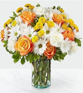 Sweet Moments Bouquet - Through a collection of bold hues, gorgeous flowers, and fresh scents, this bouquet blossoms with beauty in any room that its placed. An array of orange roses, variegated pittosporum, and white daisy pompons come together in a cylindrical glass vase to make the perfect gift for a loved one near or far.