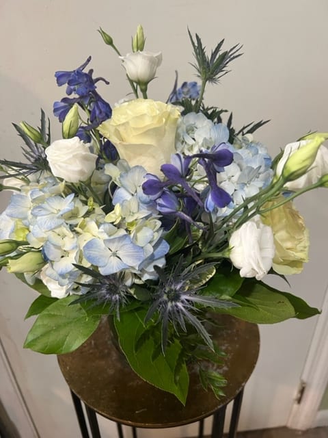 Beachside Beachside - A New England coastal feel with blue hydrangea, thistle, and white roses