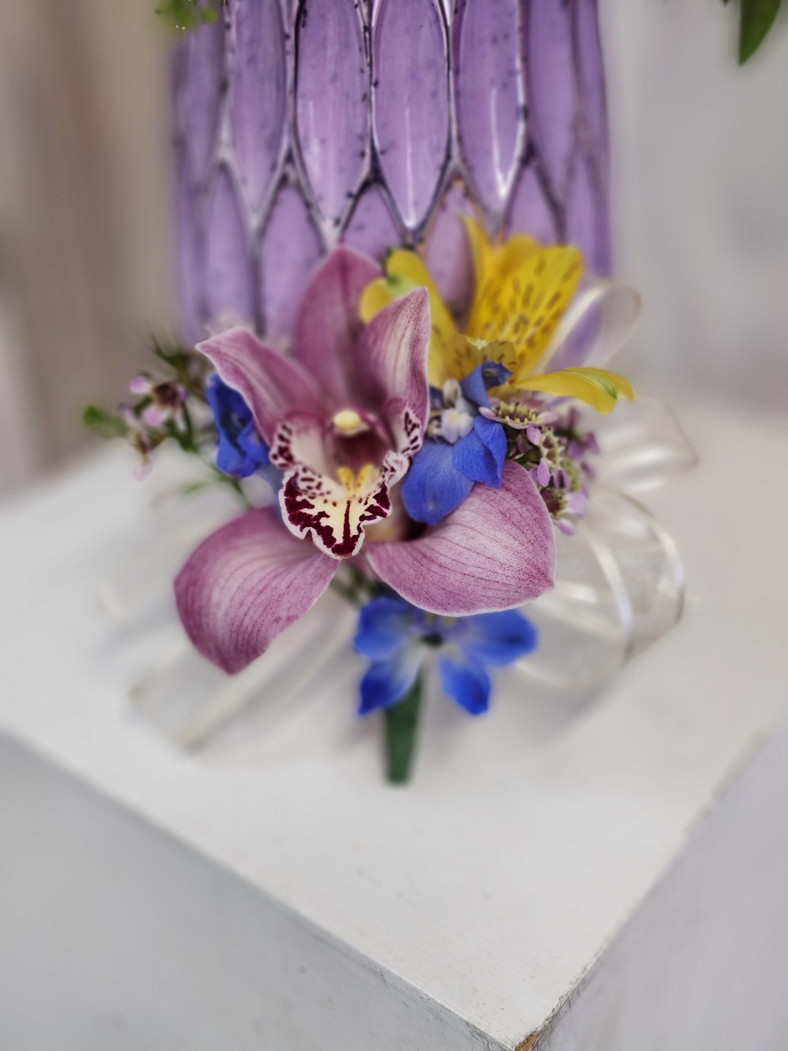 Mother's Day Boutanierre  - Have your special mom wear a beautiful floral boutanierre of cymbidium orchid and ribbon, colors may vary due to low stock, choose your color of ribbon.