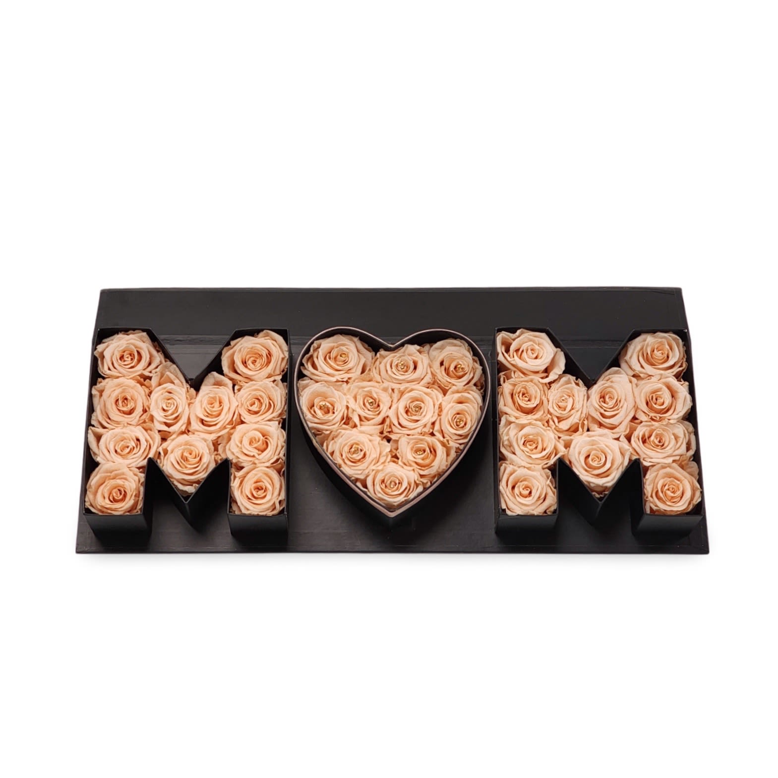 MOM Love Box – Peachy Edition MOM Love Box – Peachy Edition - Celebrate Mom with a soft and elegant touch. The MOM Love Box – Peachy Edition features delicate peach-toned preserved roses arranged in black letter-shaped boxes that spell out “MOM,” with a heart-shaped center to show just how much she’s loved. It’s a beautiful and memorable gift for Mother’s Day, birthdays, or any day you want to make her feel extra special. This unique arrangement doubles as a keepsake she’ll cherish long after the flowers are admired.