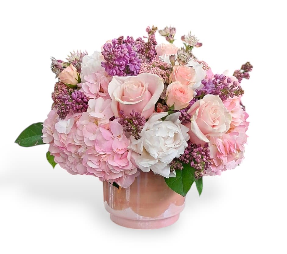 Celestial Blush Celestial Blush - This stunning arrangement has pink spray roses, roses, hydrangeas, rice flower, white peonies, lilacs, and astrantia major in a pink vase.