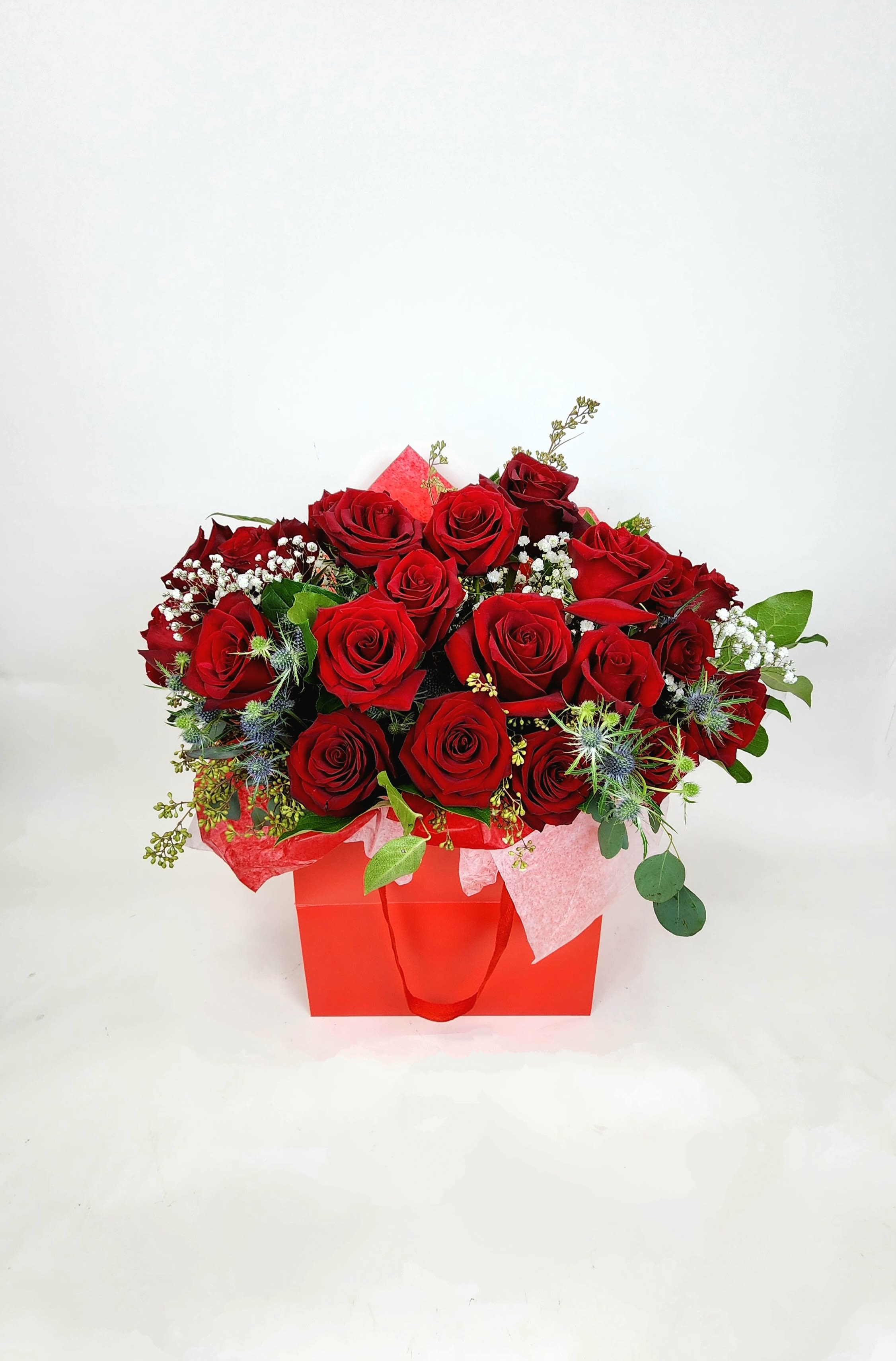 Love Red Roses  - A bouquet of red roses ( 12,18 and 24 ) wrapped in tissue paper, inside of a paper bag to hold.