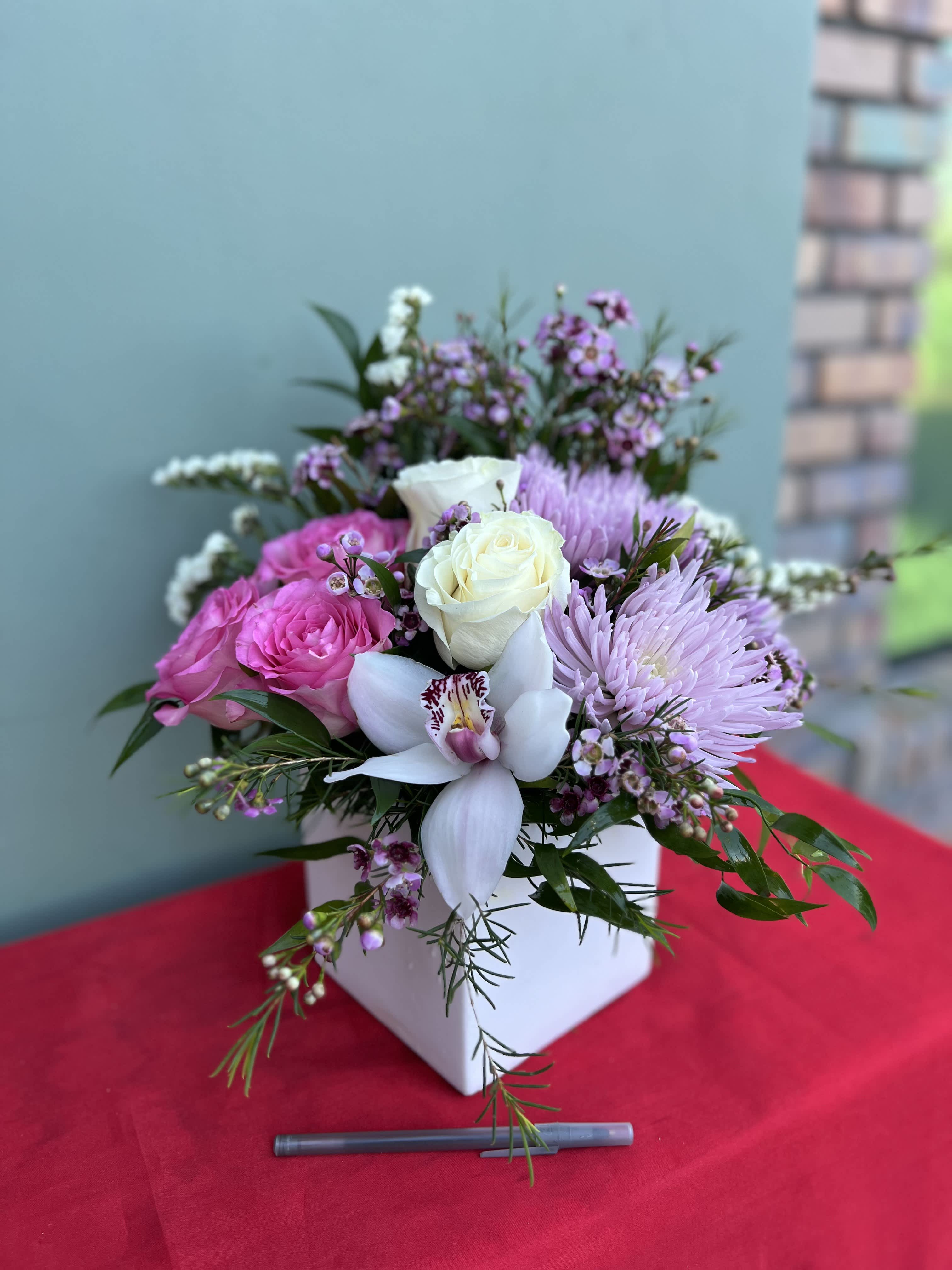 Hillside Blooms Hillside Blooms - This beautiful arrangement is sure to make anyone's day. A blend of roses orchids and other gorgeous flowers blended in a one of a kind vase.