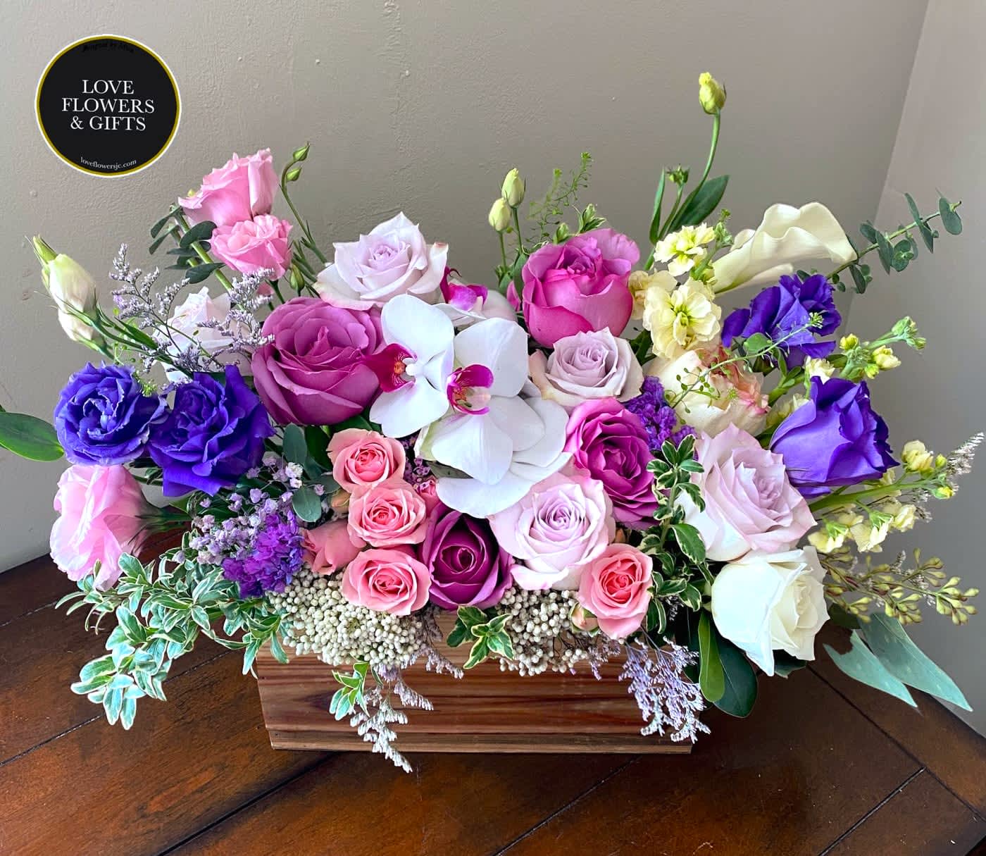 Lavender (Wide Box) - Elegant textures and colors of lavenders and pinks with orchids designed in a wide wooden box. 