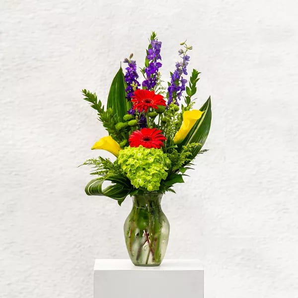 Shine Bright Shine Bright - Cheer up a loved one up with this bright assortment of gerbera daises, calla lilies, hydrangea, larkspur and more.