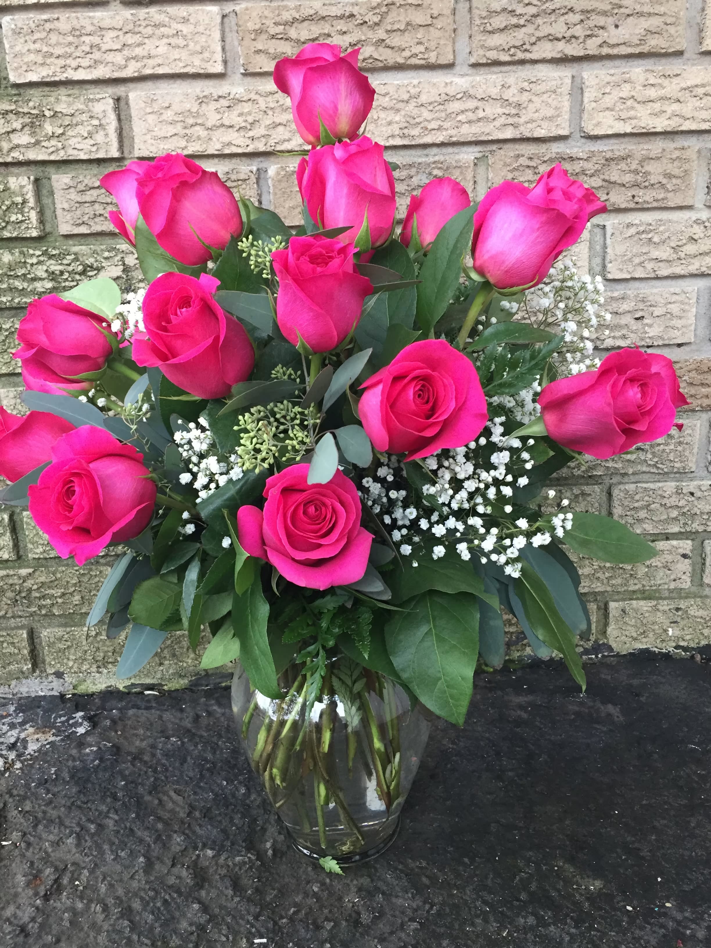 Dozen Long Stemmed Hot Pink Roses - 12 Hot pink roses with baby’s breath, fillers &amp; greenery.  Perfect for any occasion. 