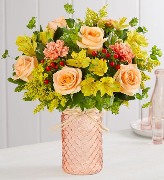 Confetti in Peach - Bring the celebration of Fall to your home. This peach quartz mason jar, a textured container designed in a honeycomb pattern and finished with a raffia bow adds charm to the warm orange and yellow blooms. Our florists hand-design each arrangement, so colors and varieties may vary due to local availability.