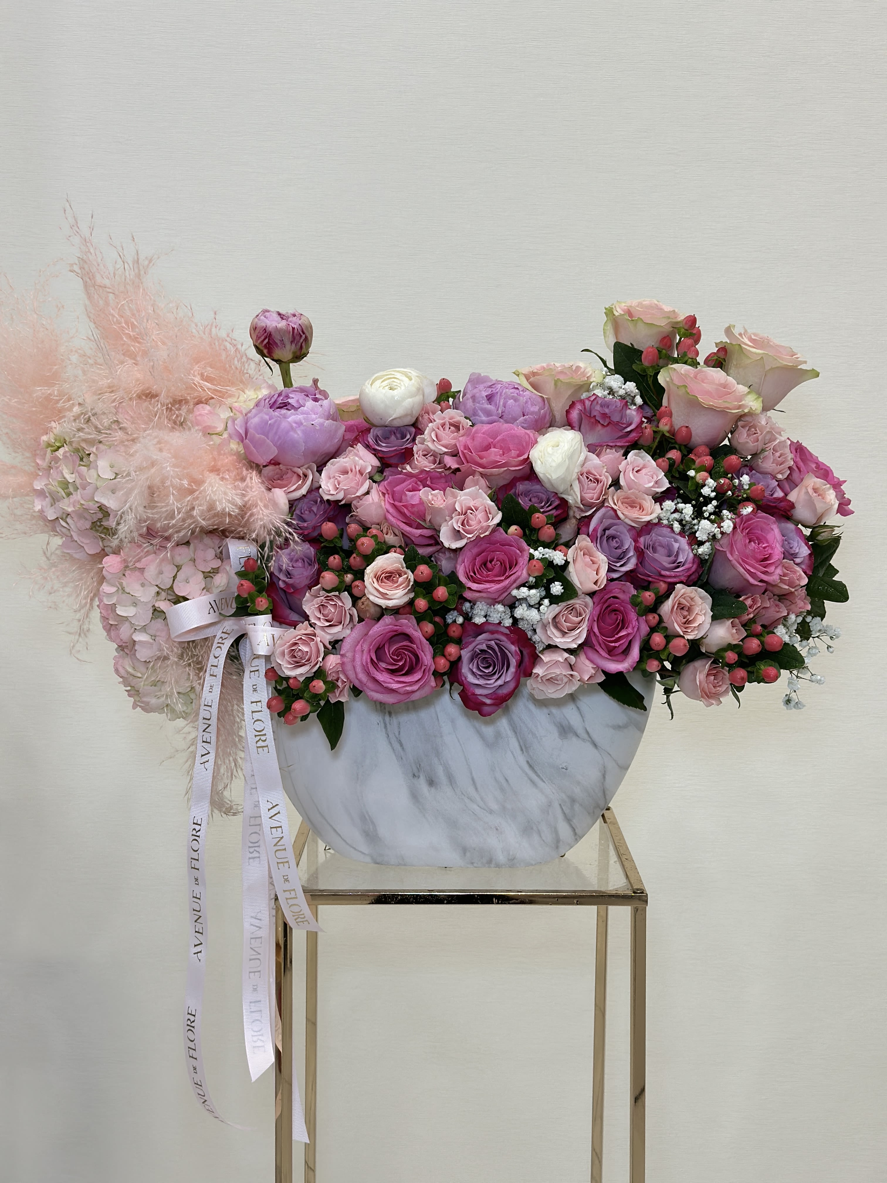 Sugar Plum Peony Garden - This gorgeous vase arrangement is filled with a mix of pink and purple flowers, making it the perfect gift to brighten someone’s day.