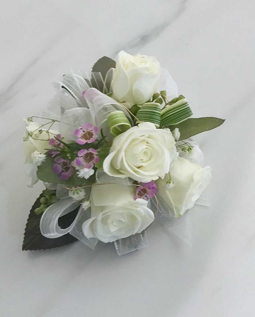 Classic Corsage  - The &quot;Classis Corsage&quot; is a small bouquet worn on a woman's dress or around her wrist for a formal occasion. Corsages have come a long way and can be customized as you wish. Corsages are most commonly seen at weddings, homecomings, proms, and formal events. 