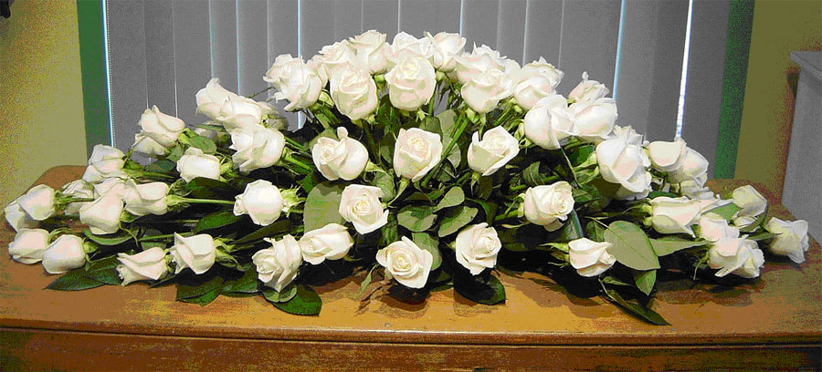 Sublime Casket Cover Sublime Casket Cover - An exquisite collection of flowers, including white roses, spray roses, and others, elegantly extends to cover the entire casket. Notes: This can be designed in the color(s) and flower(s) of your choice. Depending on the type of flowers you select, additional fees may apply. Sympathy banners are available to enhance this product for an additional fee.
