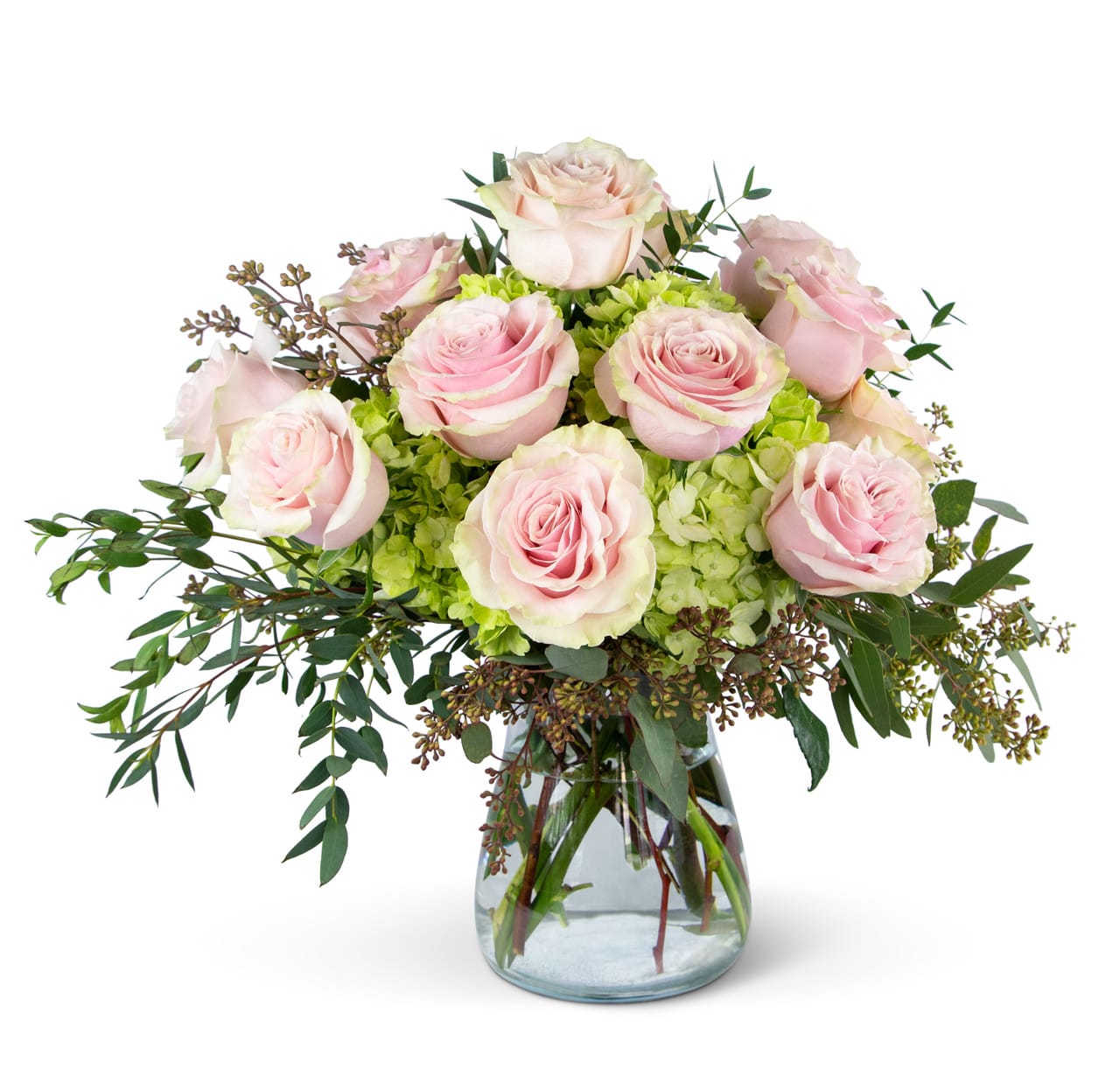 Pink Dream Roses - A beautiful combination of a a dozen light pink roses nestled in bright lime green hydrangeas and accented with seeded eucalyptus and parvifolia. Styled in a clear vase. Perfect for any occasion