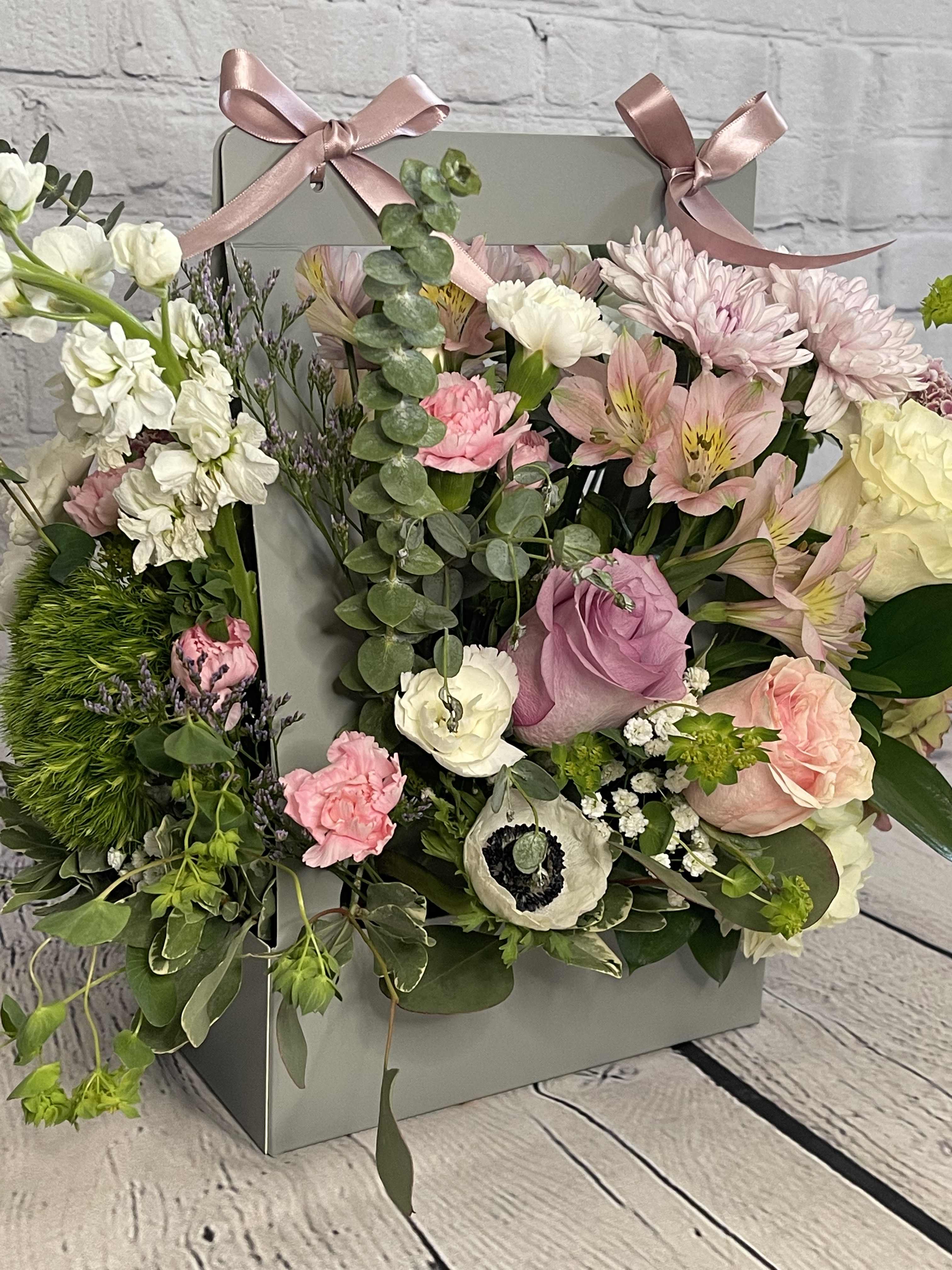 Dream Basket - Introducing the Dream Basket - the epitome of elegance and charm for all your floral fantasies! As passionate florists, we understand that flowers have the power to convey emotions and create unforgettable moments. Our Dream Basket is meticulously crafted to delight and enchant, making it the perfect gift or centerpiece for any occasion.   Imagine a stunning bouquet of flowers, meticulously arranged in a beautiful box, resting gracefully on the floor. The Dream Basket is a vibrant symphony of colors and fragrances, designed to captivate your senses and transport you to a world of pure bliss. With a diverse selection of pale blossoms carefully handpicked by our skilled artisans, each Dream Basket is a unique masterpiece that exudes natural beauty and sophistication. 