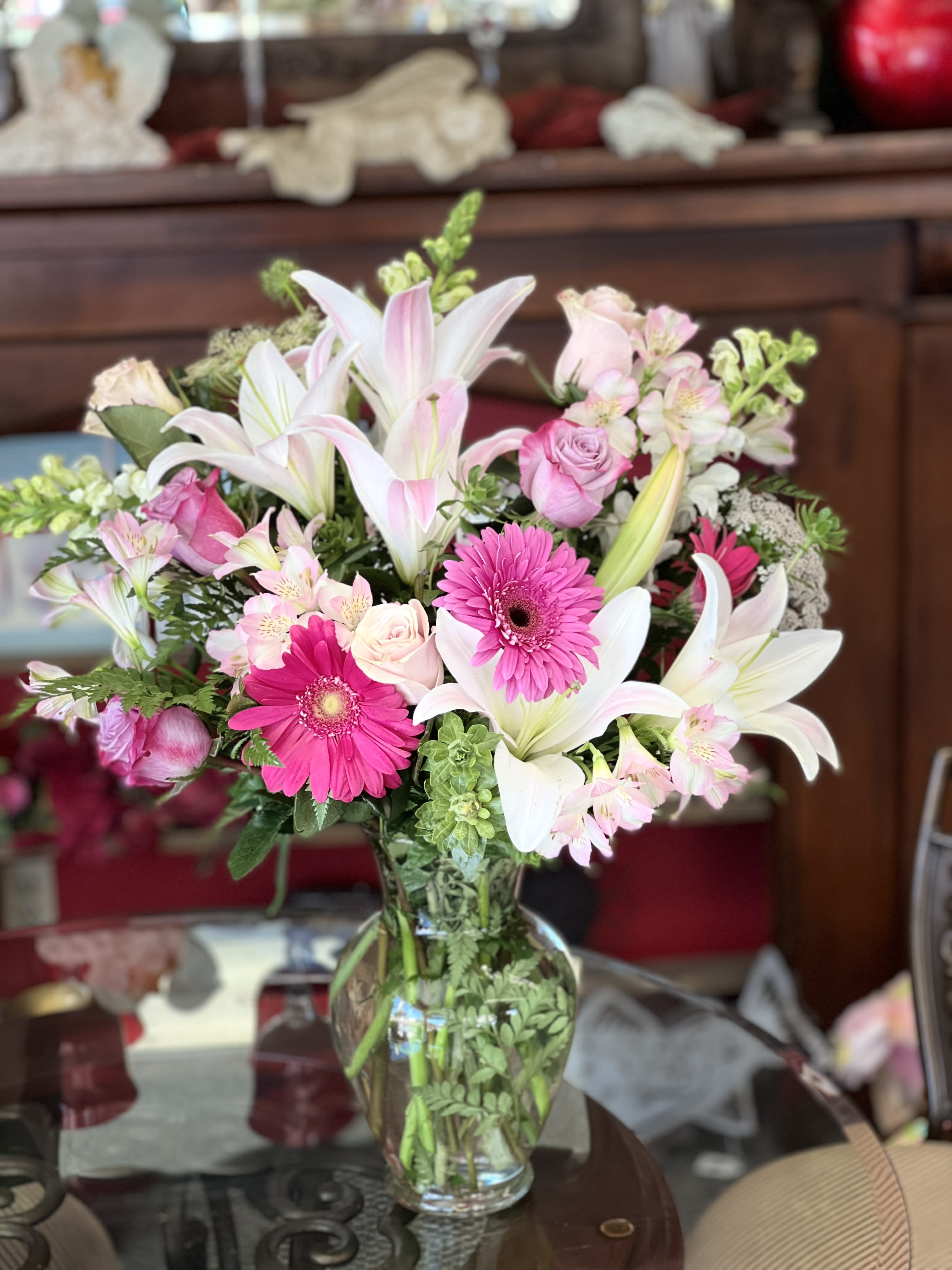 Lucky In Love - Win her love all over again with this delightful array of pink roses, pink lilies and other favorites in a dazzling clear glass vase. Imagine her excitement when this appears at the door. Product ID: T526-1A 