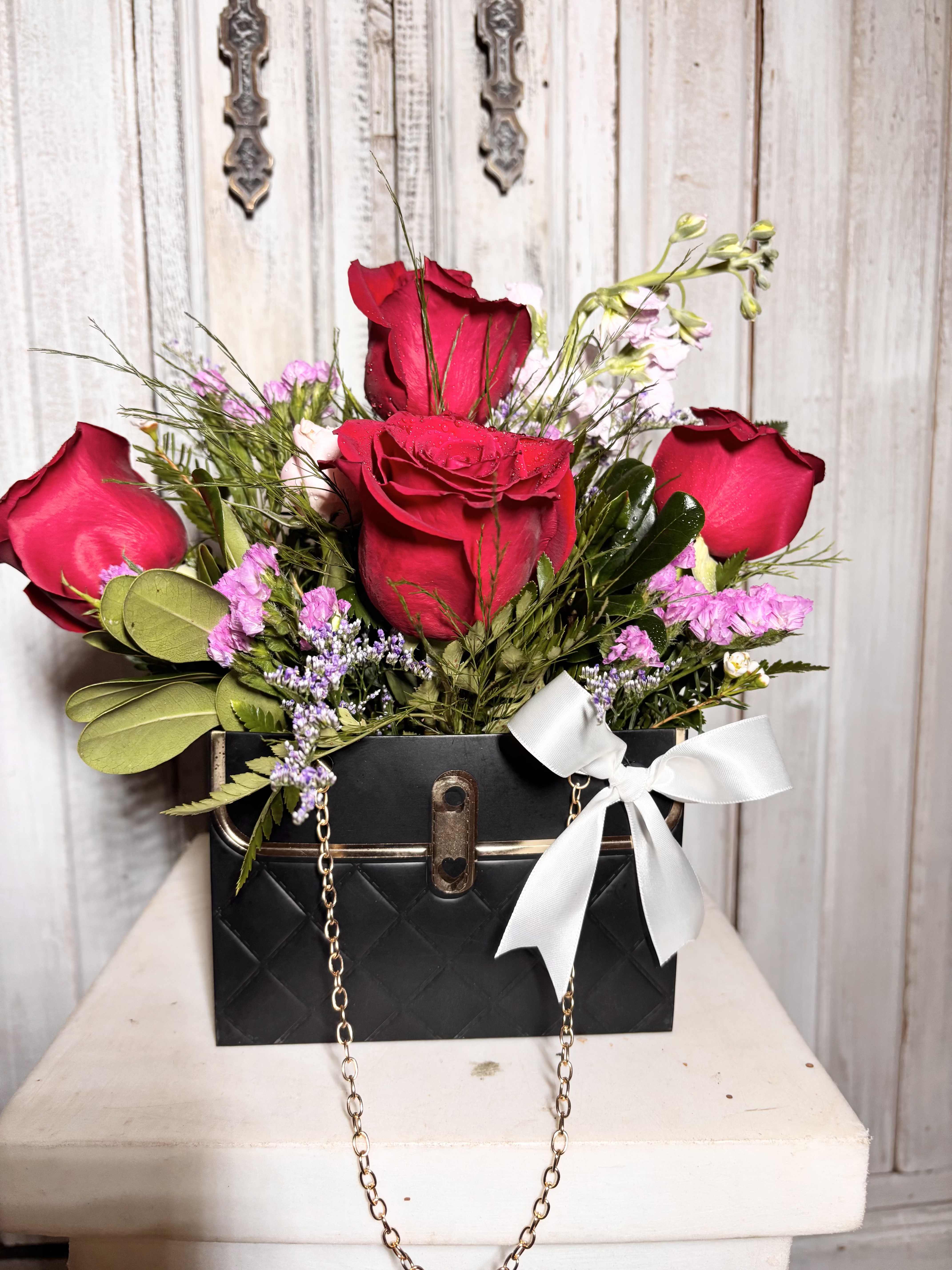 Little Black Purse Little Black Purse - This arrangement contains roses and greenery filler.