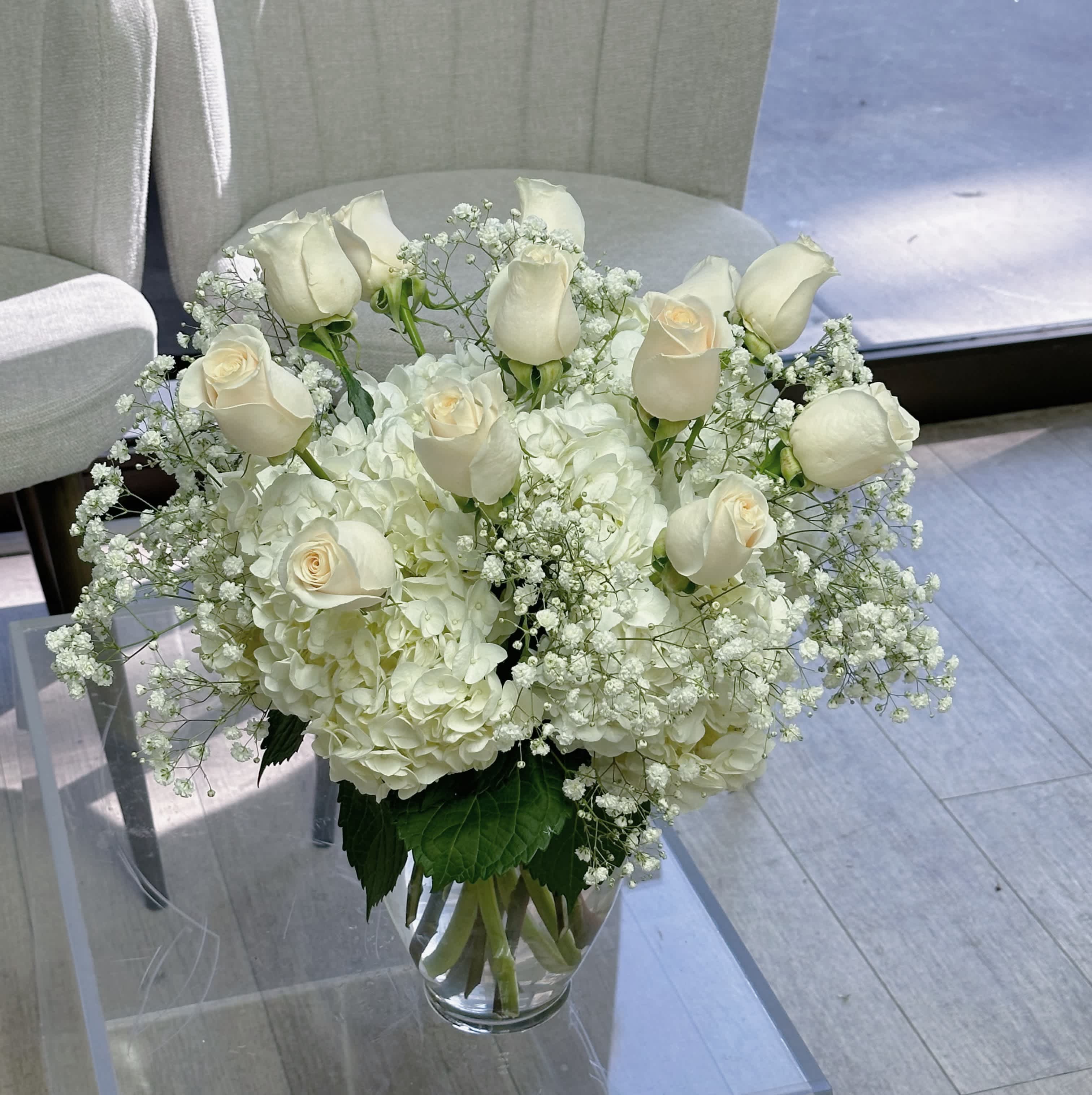 One dozen white roses - One dozen white roses accompanied with hydrangeas and gypsophila 