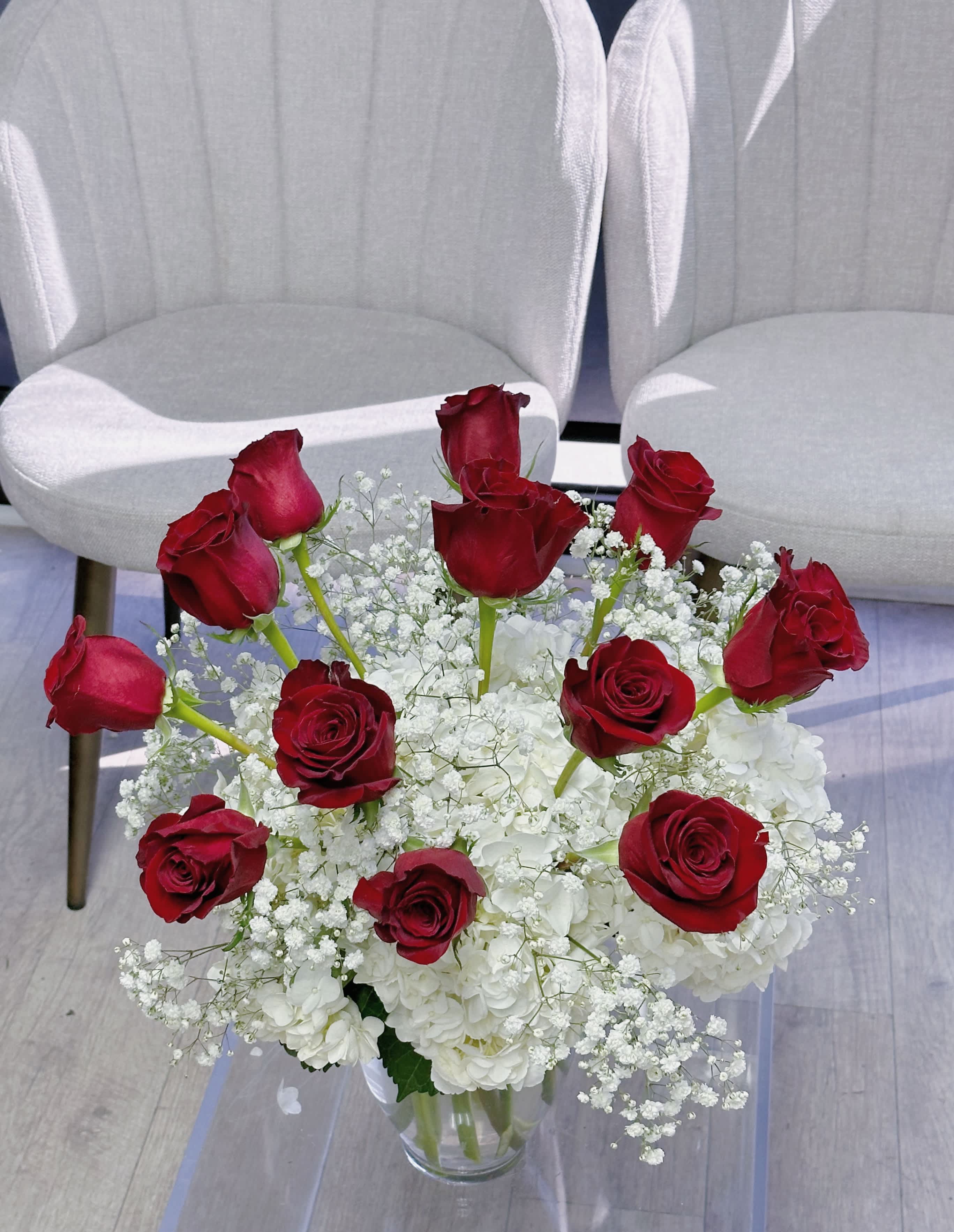 One dozen red roses - One dozen purple roses in a vase, accompanied with white hydrangeas and gypsophila flowers 