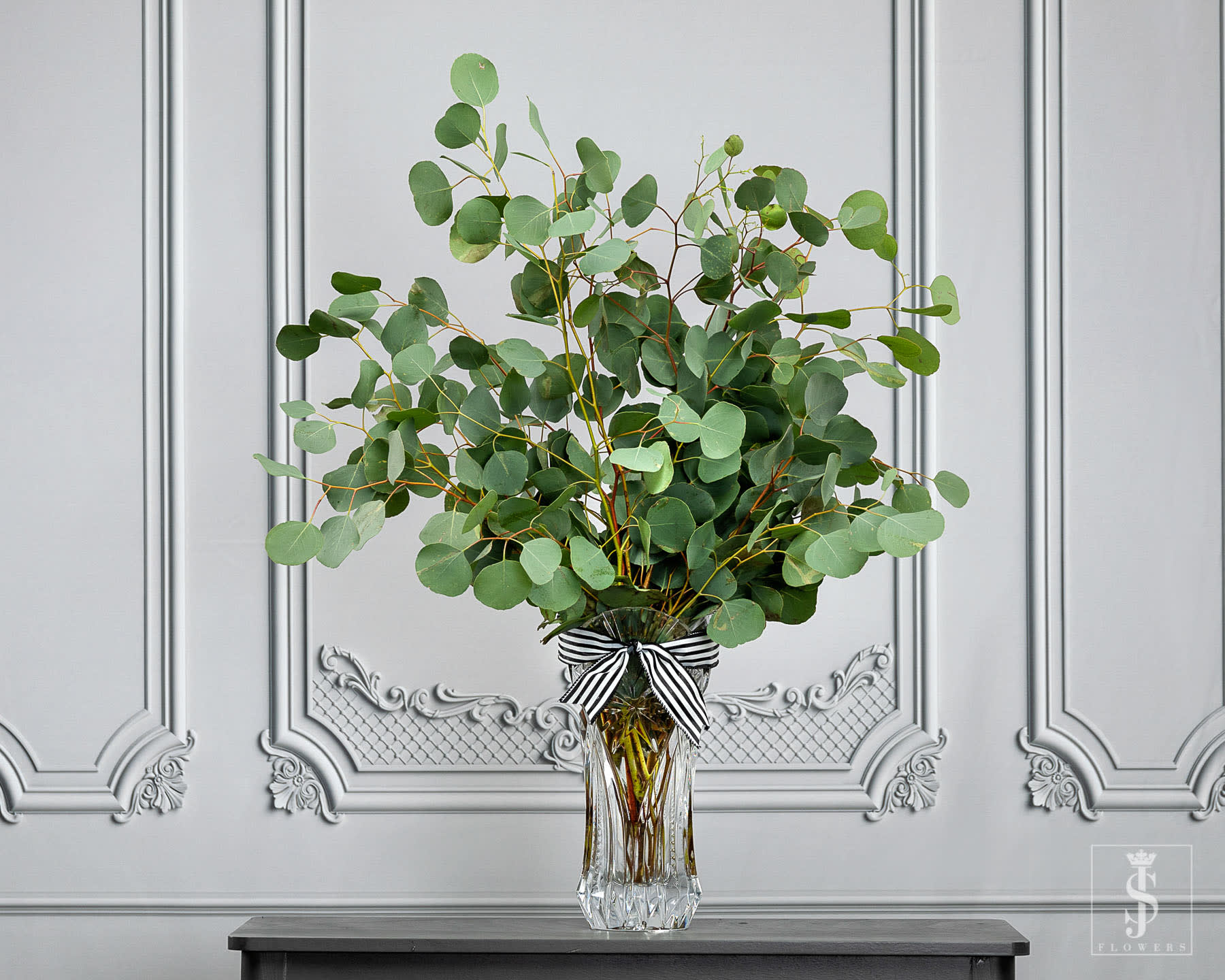 Sliver Dollar Eucalyptus Greens - This item is sold by the bunch. Silver dollar eucalyptus is one of the most popular greens that DIY housewife's, brides, party planners request for creating floral masterpieces. These greens consist of lovely rounded leaves (can vary in shape) on a tall, flexible stem, and add soft volume to bouquets, centerpieces, and ceremonial décor. They truly have a chameleon-like personality and can go from rustic to romantic in a flash depending on how you arrange them. Eucalyptus is exquisite when loosely paired with garden roses, ranunculus, and Veronica for a lavish arrangement. For a chic garden wedding, try adding silver dollar eucalyptus for a sweet finishing touch alongside larkspur, astilbe, wax flowers and roses in a Mason jar or rustic watering can. These stems also make stunning garlands, decorative arches, and table runners accented with a few colorful blooms.  *Fall season (mature) Silver Dollar Eucalyptus leaves may be longer and thinner in shape.  Call for Wholesale Pricing (469)900-8095  Send your Beautifully Wrapped Fresh Flowers today. The stems will arrive wrapped in  JS Flowers tissue and cellophane.. **Please note the vase is not included!   Important Information:  * Orders placed on Monday will process on Tuesday for Wednesday delivery.  * Orders placed on Tuesday will process on Wednesday for Thursday delivery.  * Orders placed on Wednesday will process on Thursday for Friday delivery.  * Orders placed from Thursday to Sunday will process on the following Monday for Tuesday delivery.  * Orders will not be delivered on Saturdays and Sundays.   All flowers are Shipped/Delivered during their freshest state so that you can enjoy them for as long as possible! Please be aware that upon arrival flower heads will be tight, allowing you to enjoy every moment of them maturing into full blooms! Photos displayed on this website are taken during each flowers most mature state.  