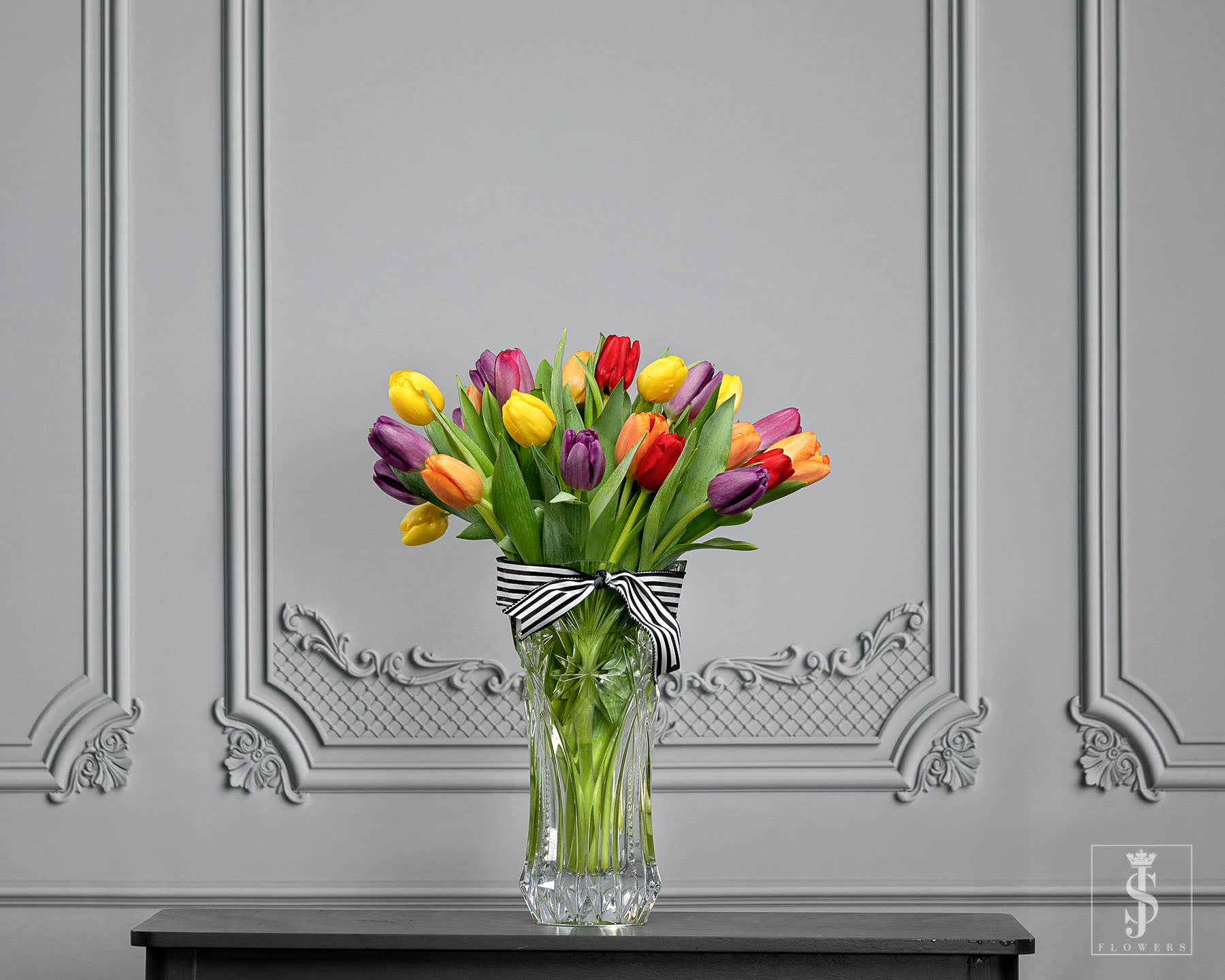 Tulips  - This item is sold by the bunch. 20Stems/ 2-Bunch wrap Mixed Color or any color tulips adding a touch of class to our home or special event. The best part about tulips, the petals are delicate with a bright, bold, warm charm. You can enjoy tulips in your bouquets year-round. The bright loving tulips is a welcome into spring!  Pair these whimsical blooms with ranunculus, eucalyptus greenery, mixing flower textures as you go!  For necessary items like containers, cutters, swiss army knife, and more shop our floral supplies. Creating beautiful, quality arrangements at home is easier with the right tools. Be prepared with JS Flowers! Send your Beautifully Wrapped Fresh Flowers today. The stems will arrive wrapped in  JS Flowers tissue and cellophane.. **Please note the vase is not included!   Important Information:  * Orders placed on Monday will process on Tuesday for Wednesday delivery.  * Orders placed on Tuesday will process on Wednesday for Thursday delivery.  * Orders placed on Wednesday will process on Thursday for Friday delivery.  * Orders placed from Thursday to Sunday will process on the following Monday for Tuesday delivery.  * Orders will not be delivered on Saturdays and Sundays.   All flowers are Shipped/Delivered during their freshest state so that you can enjoy them for as long as possible! Please be aware that upon arrival flower heads will be tight, allowing you to enjoy every moment of them maturing into full blooms! Photos displayed on this website are taken during each flowers most mature state.   