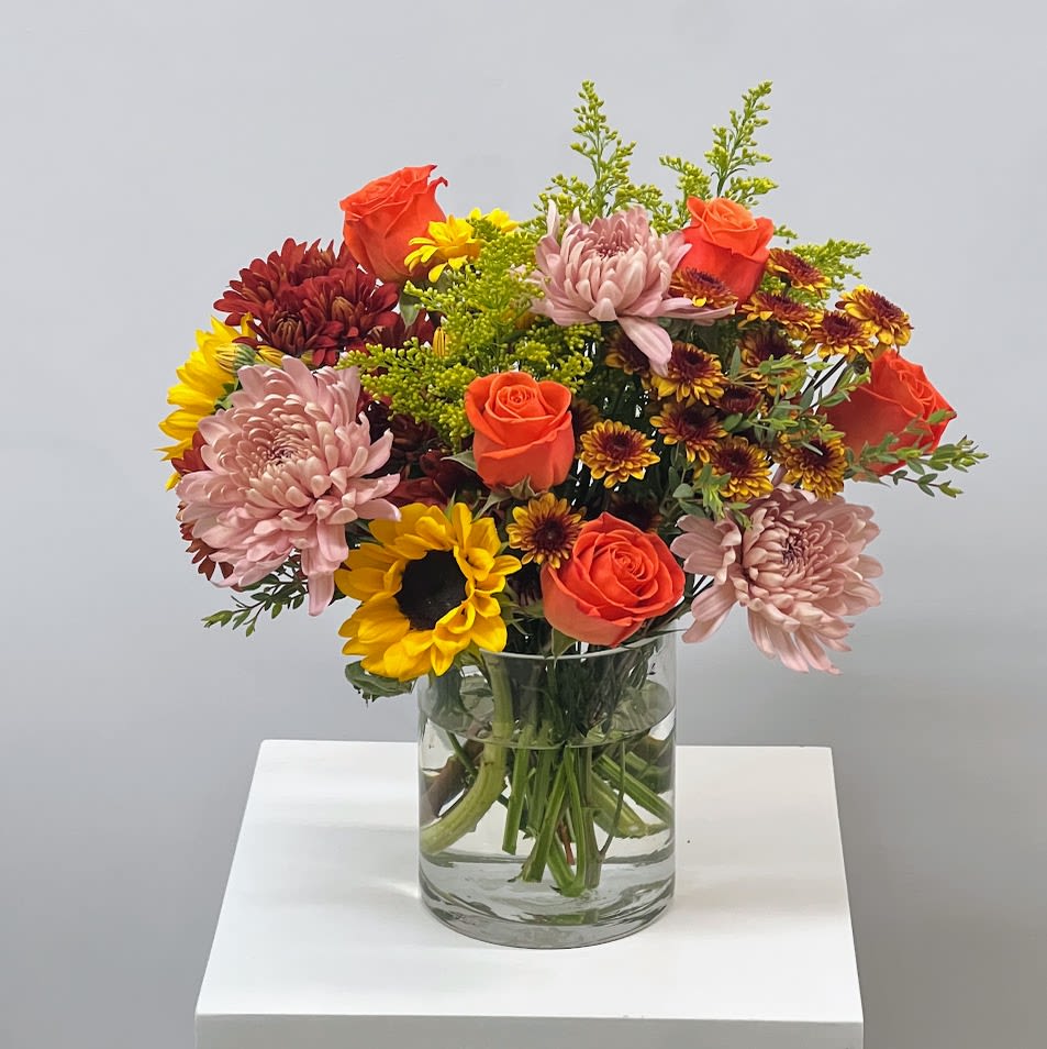 Autumn Colors - This small fall-inspired flower arrangement bursts with the warm and vibrant hues of the season. Featuring delicate orange and yellow blossoms intermingled with rich autumn colors, this bouquet exudes a sense of coziness and comfort. Perfect for bringing a touch of fall beauty to any space.