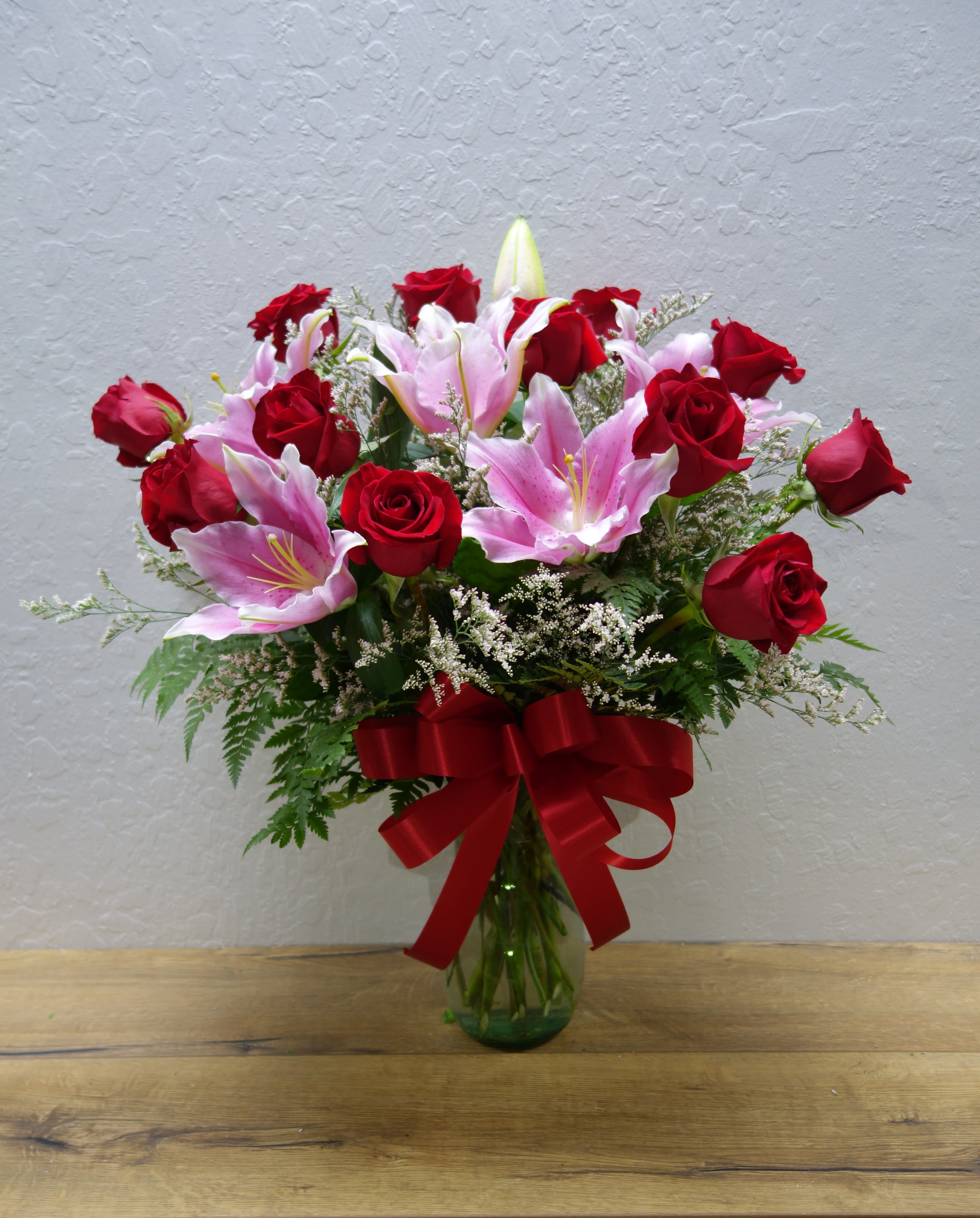 Perfect Love - The chemistry between these roses and stargazers... it's a perfect love! This arrangement features roses, stargazers, and mixed foliage.   Standard (as shown): 12 roses Deluxe: 15 roses Premium: 18 roses