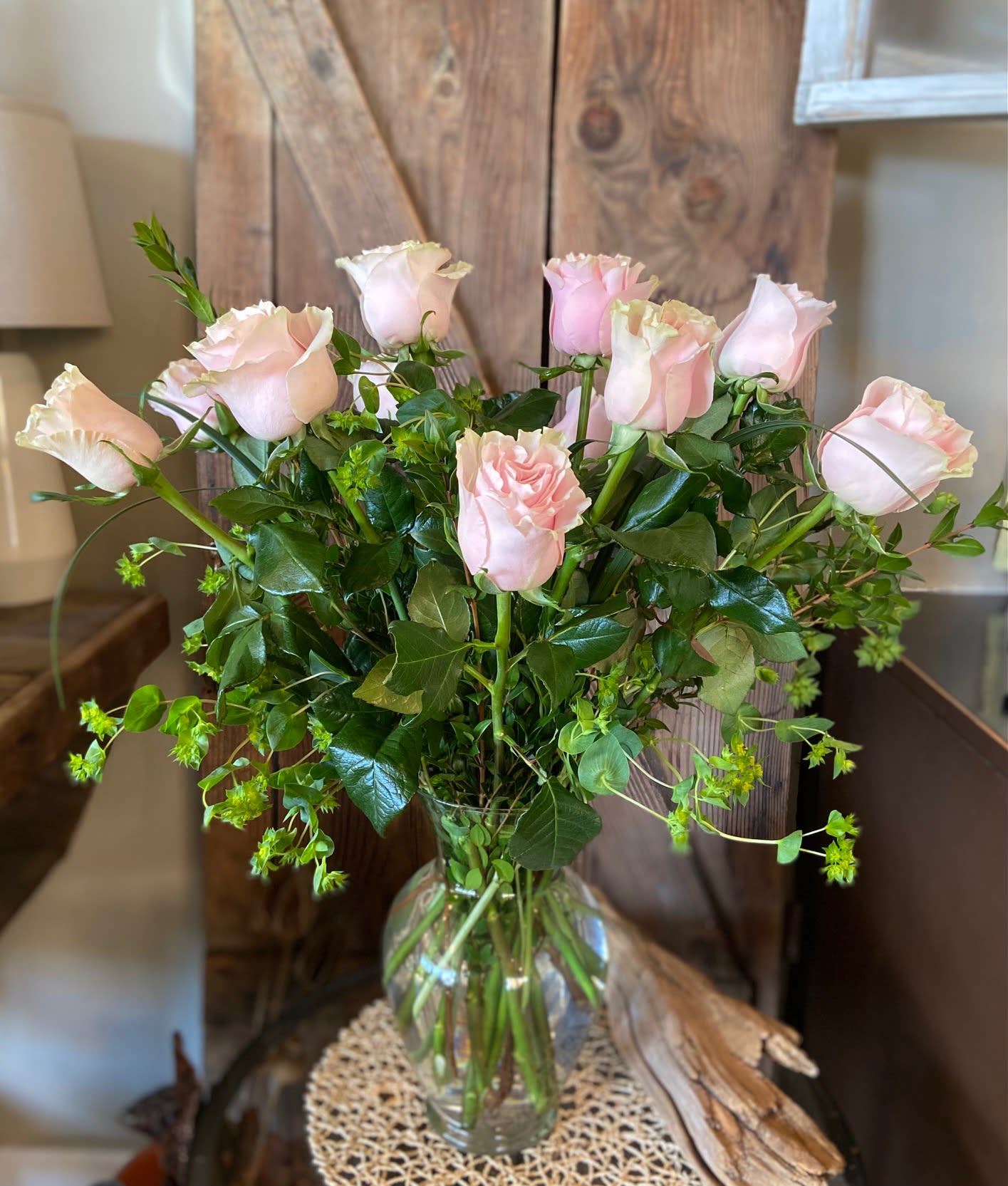 One Dozen Soft Pink Roses - Dreamy Soft Pink Roses Arranged Tastefully in a Clear Vase with Premium Greenery.