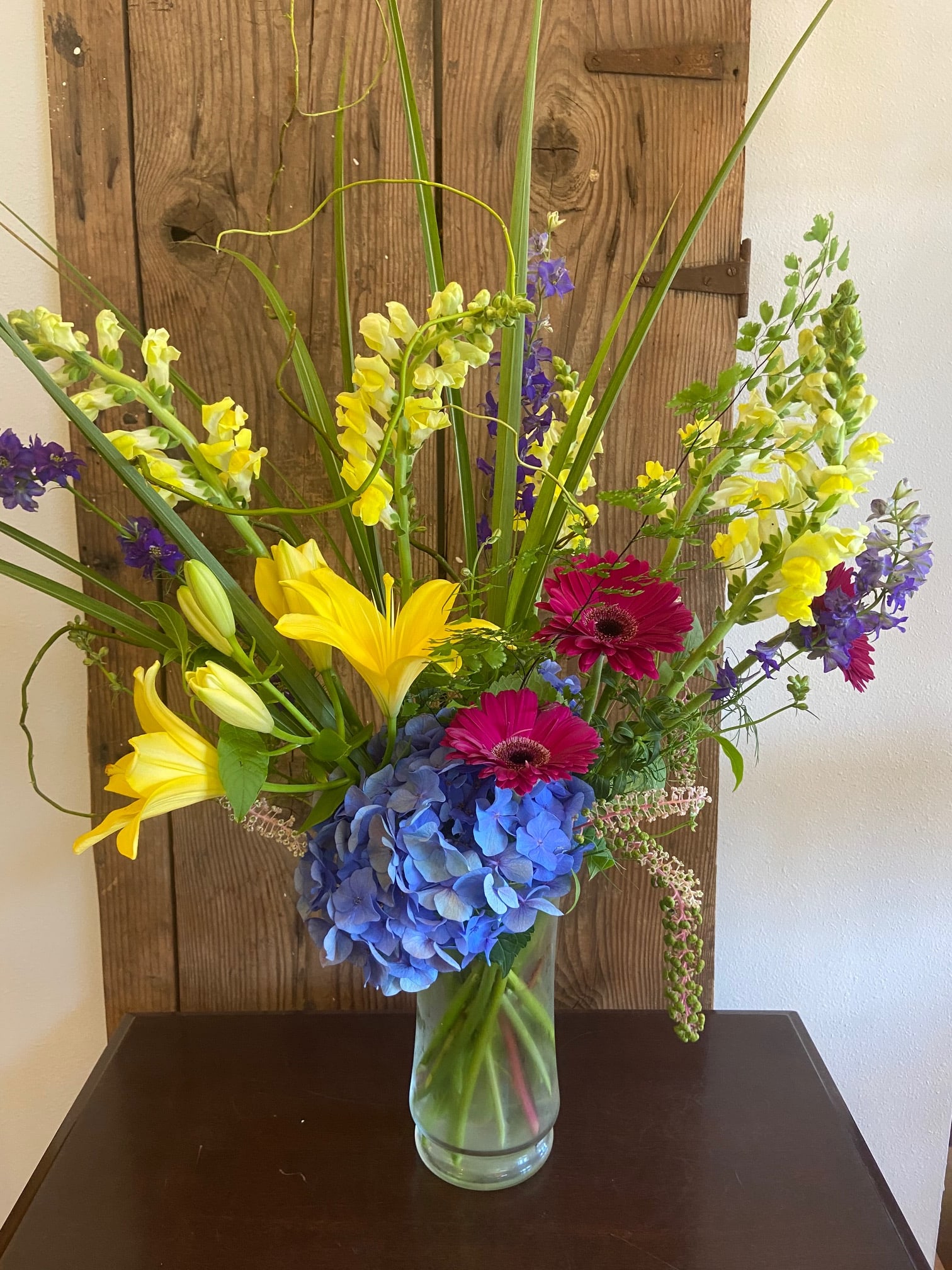 Showy Tall Bright Blooms - Assortment of Garden Flowers Arranged in a Tall Clear Vase. **COLORS/FLOWERS may vary.