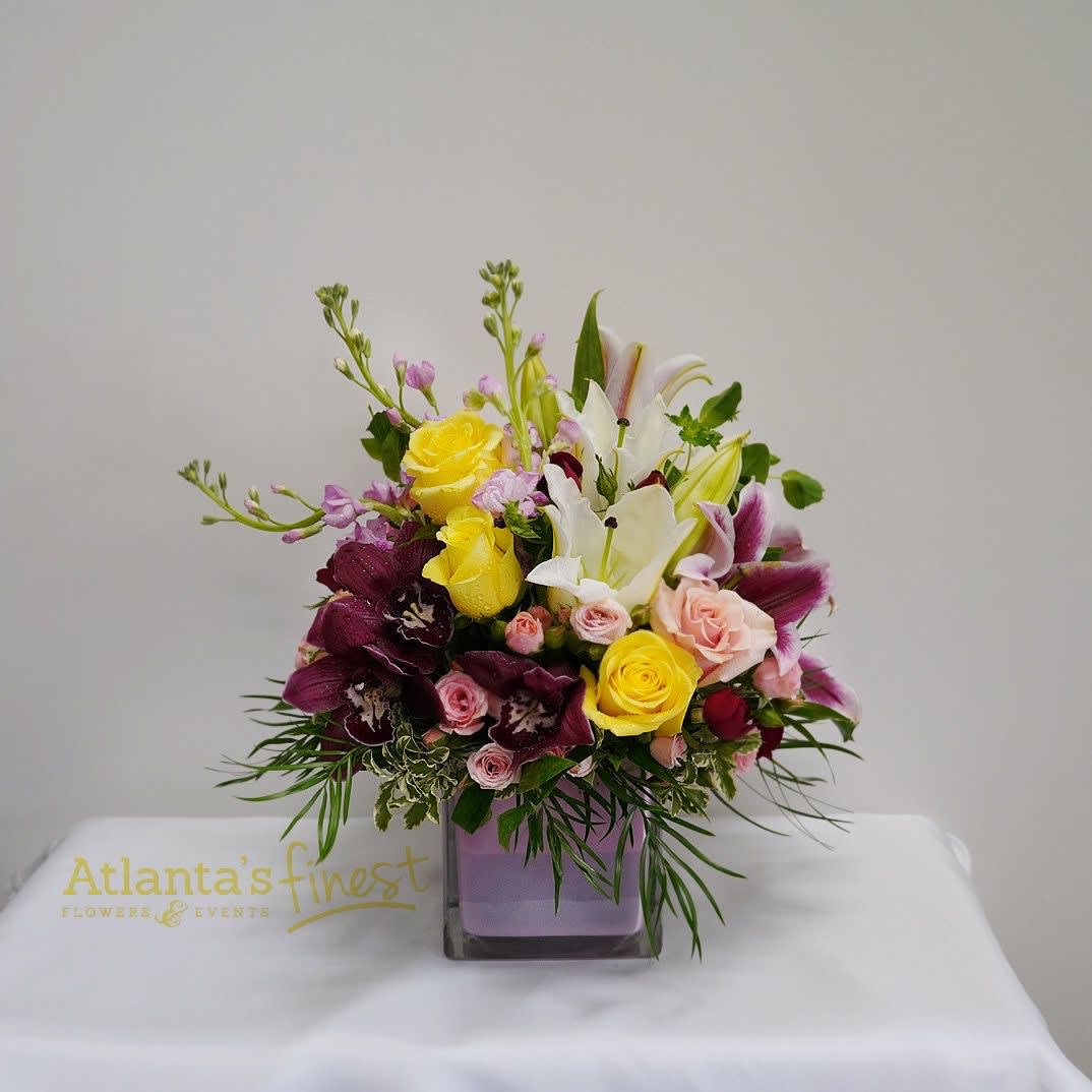 Cheerful Bouquet with cymbidium orchids by Atlanta's finest flowers Cheerful Bouquet with cymbidium orchids by Atlanta's finest flowers - mix of flowers is a cheerful gift for any occasion. Hand-delivered in our exclusive Color Splash cube, these pink and yellow roses and pink , white lilies are guaranteed to please! arrangement includes cymbidium orchids , roses spray roses , stock and mixter greenery