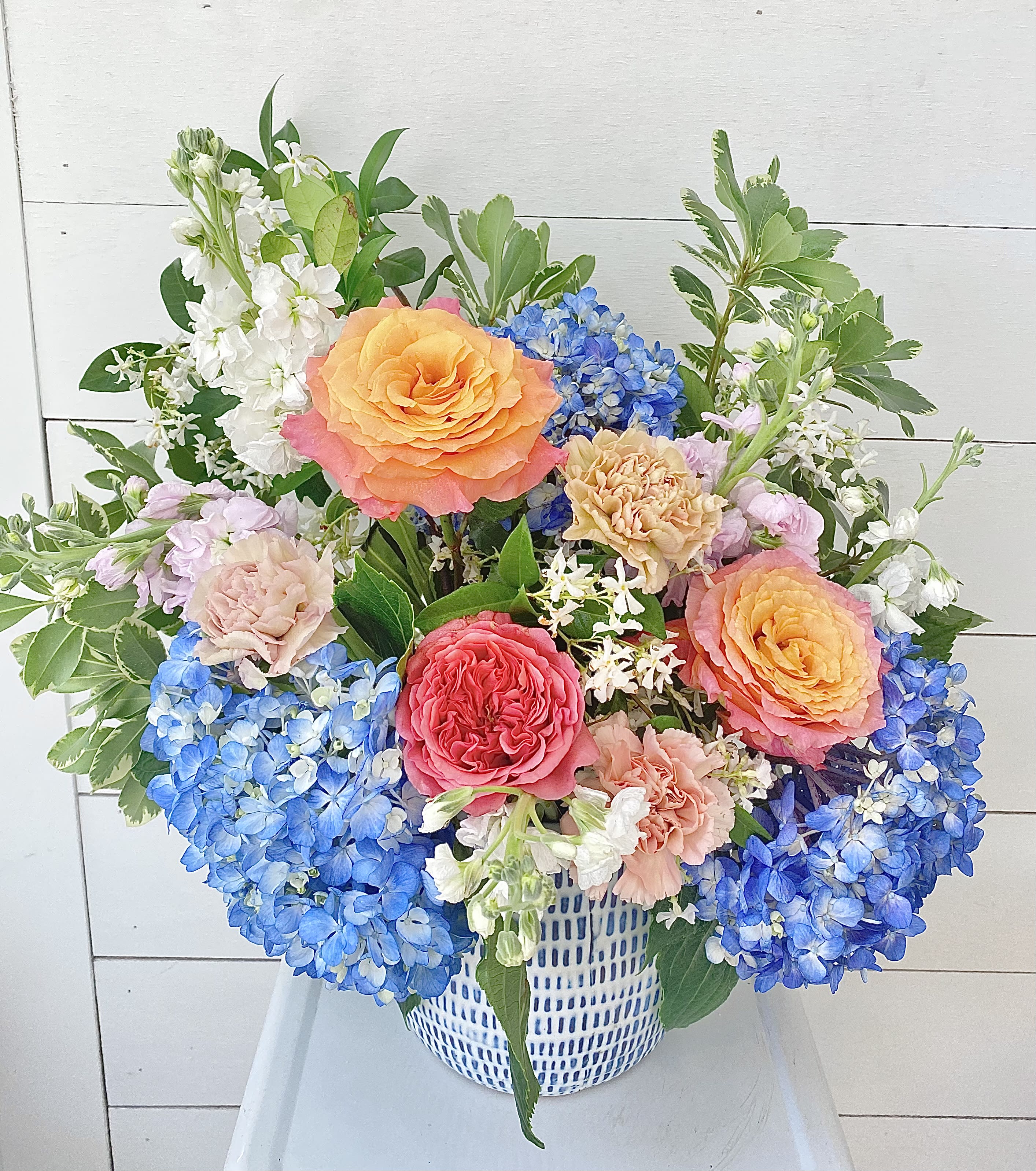 The Elizabeth  - My daughter Sabine and I just named this lovely, fluffy arrangement. (Elizabeth-Grey is her middle name) It is such a classic English garden type of arrangement with bright, cheerful blue hydrangeas, pink and sunset garden roses, stock and vining greenery from our gardens. 