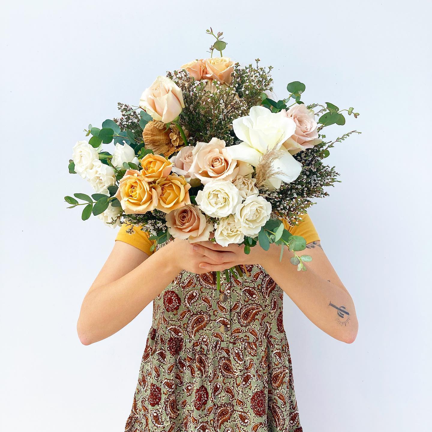 Neutral - Colored, Wrapped Bouquet Neutral - Colored, Wrapped Bouquet - Need a gorgeous, last minute bouquet? This soft, muted-color bouquet with greenery is perfect last minute weddings or elopements, anniversaries or just to say, "I Love You". Need a boutonniere to complete the look? Add one from our something special section below. This is a designer's choice arrangement and while it will most likely not have all of the same flowers pictured, it will have a very similar, organic feel.