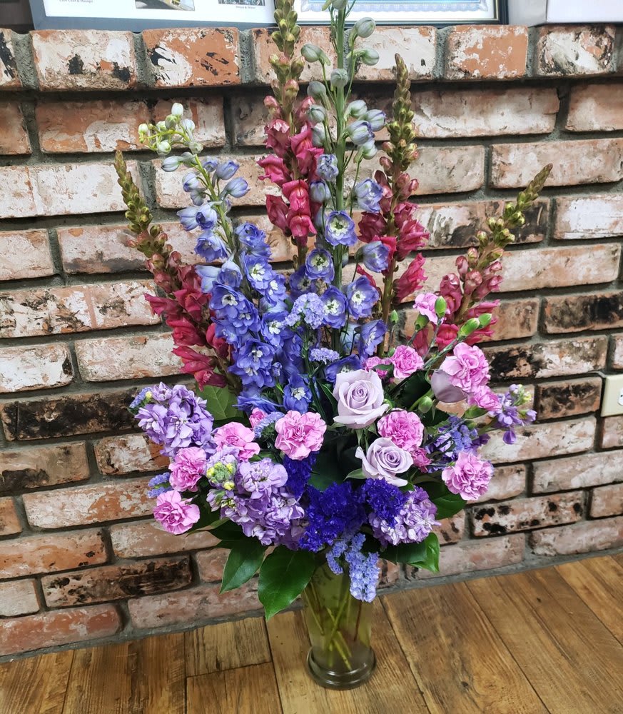 Love For Lavender Love For Lavender - Lavender Roses, stock, hybrid delphinium, snapdragons and miniature carnations in a tall glass vase