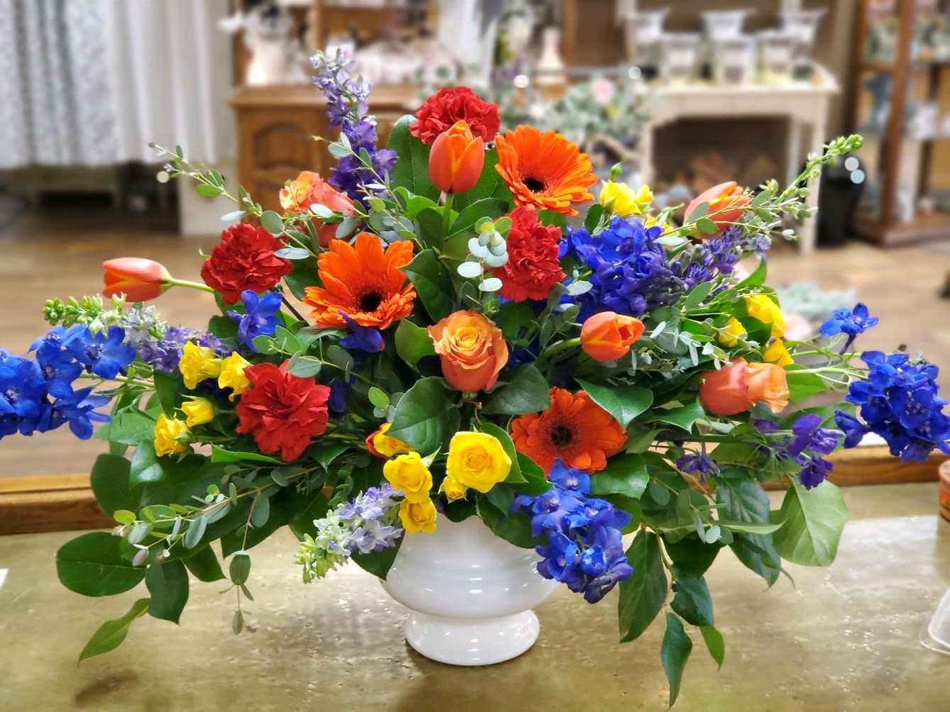 Vivid And Vibrant Vivid And Vibrant - Bright and colorful arrangement with gerbers, tulips, delphinium, carnations, roses and spray roses