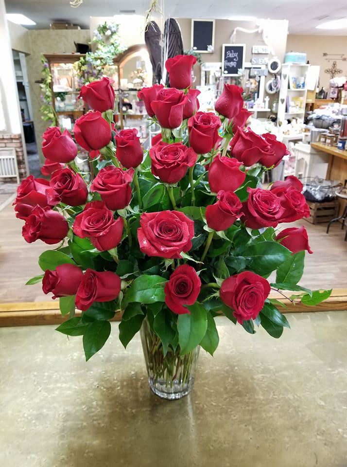 Forty Roses Vased Forty Roses Vased - Forty long stem red roses in a vase with greenery.
