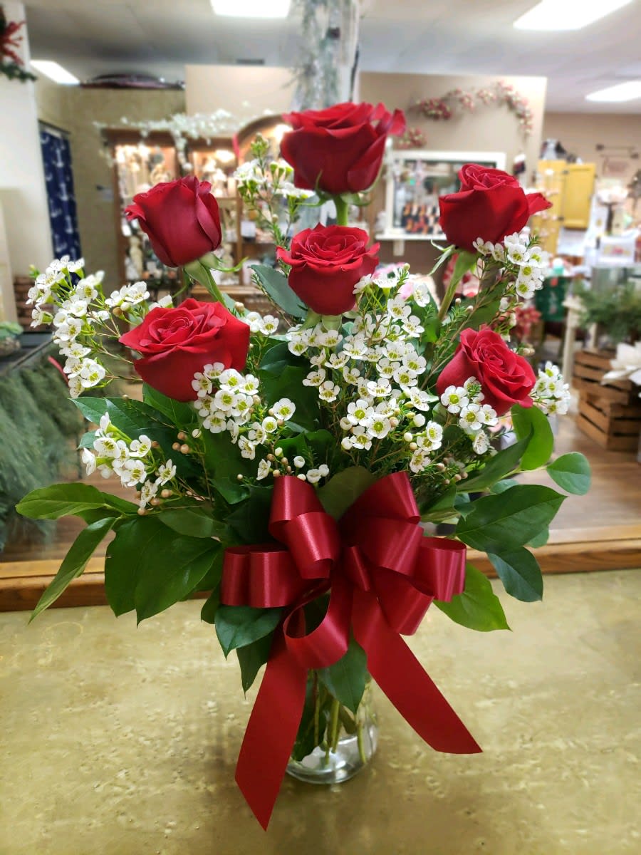 Half Dozen Red Roses Half Dozen Red Roses - Six beautiful long stem red roses in a vase with greenery and filler.