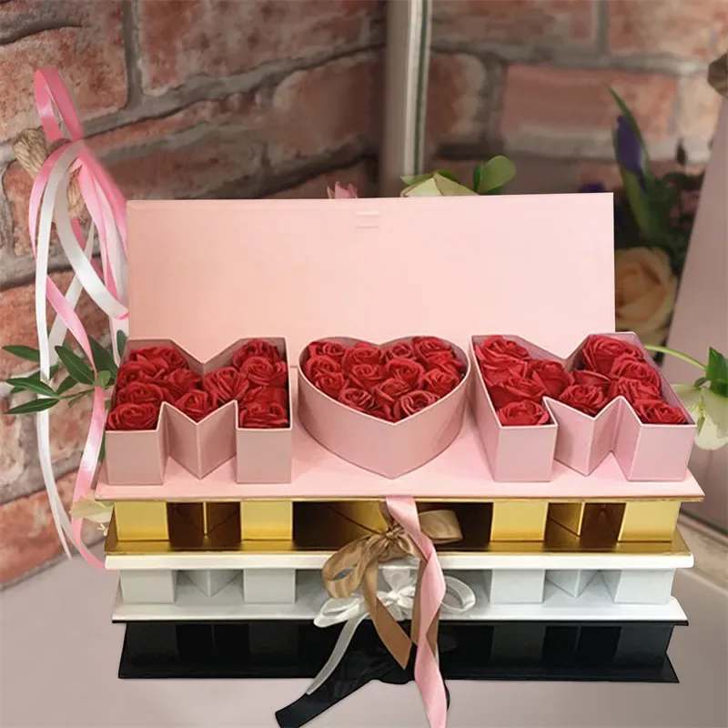MOM Luxe Bloom Box - The Ultimate Mother’s Day Statement Piece  Celebrate Mom with our MOM Luxe Bloom Box— an elegant floral gift featuring the word “MOM” spelled in white roses, centered around a heart of deep red roses. Thoughtfully arranged in a premium drawer-style box, this floral design is the perfect blend of beauty and sentiment.  What's Included:  * Fresh white roses spelling “MOM” * Heart of premium red roses * Optional gold butterfly accent (while supplies last) * Premium drawer gift box tied with satin ribbon    Box Size:** 19.5&quot; L x 6.5&quot; W x 4.5&quot; H  Available for delivery in Orlando, FL only  Fresh flower arrangement  Because nothing says “I love you, Mom” like a box full of roses and meaning.  Box Color &amp; Roses Color might vary based on availability.