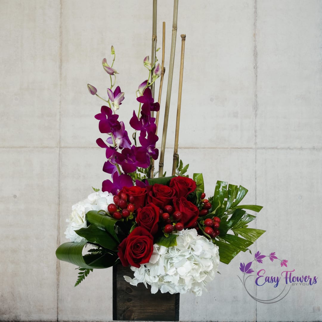 Joyful Box - Experience the abundance and depth of true joy with our exquisite bouquet of bright red roses and pink orchids, complemented by pure white hydrangeas. The outward manifestation of joy, this bouquet captures the hue of love and desire and creates an emotion that resonates with the sense of life. A box of joy that contains enormous pleasure and delight, this unique gift is sure to bring a profound sense of contentment and happiness to any occasion.