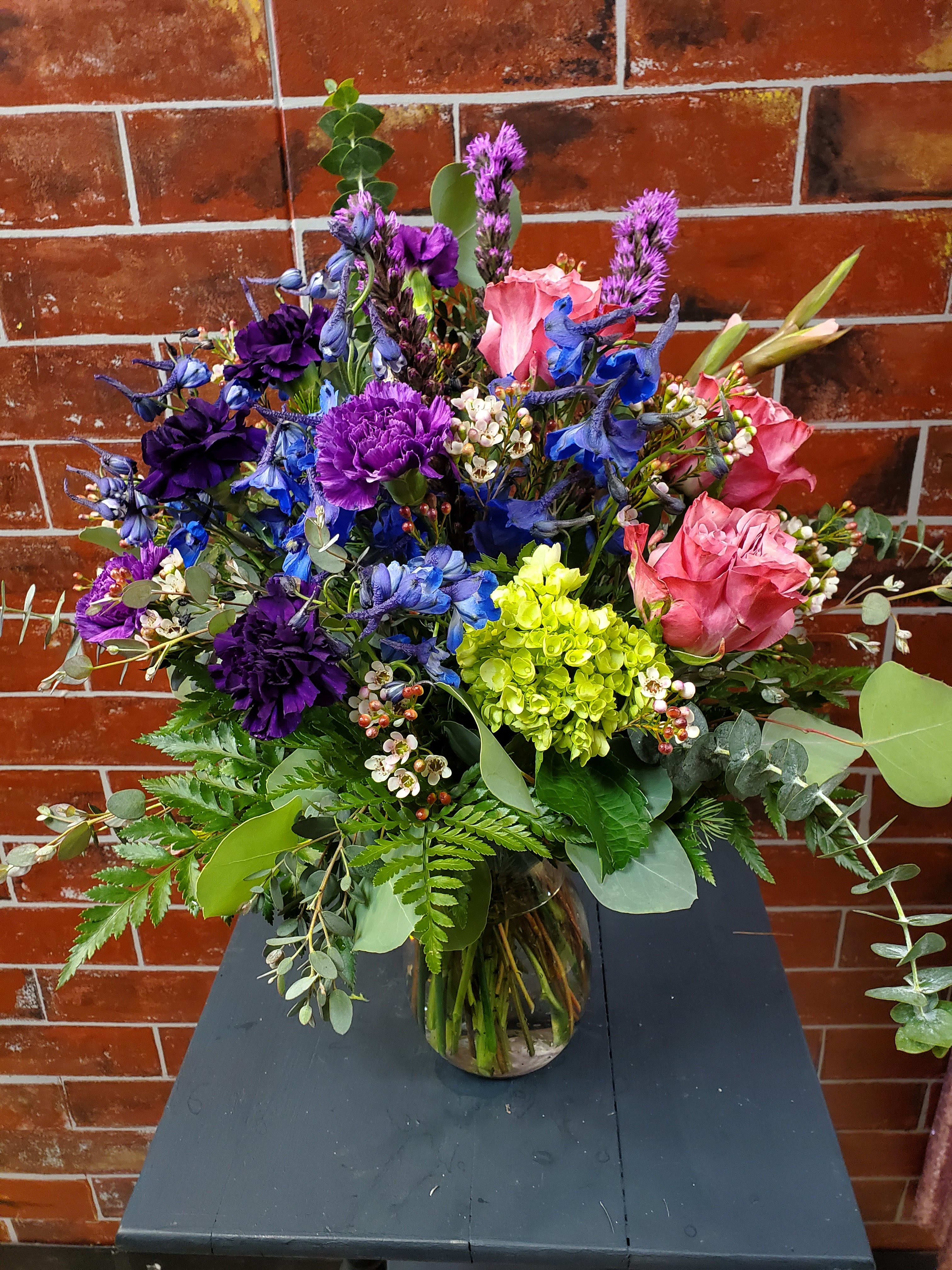 Everything Pink, Blue, and Purple. - This bouquet is designed with Pink, Blue and Purple flowers.  *Some stages of flower life may vary. (Example: Lilies may be more open than imaged.)  Flower shortages and product availability means that some substitutions will apply. Value will always be filled.  This bouquet might include eucalyptus amongst the greenery. It may be toxic to pets including but not limited to Cats and Dogs if digested.