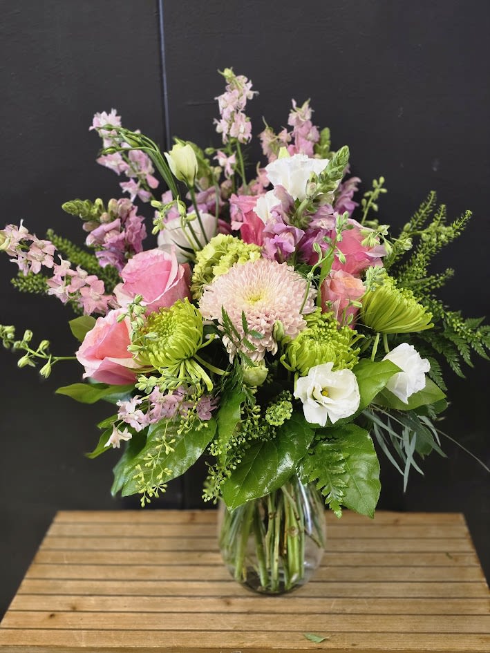 Pink and Green Perfection - A beautiful one sided arrangement designed with fresh flowers  * Some stages of flower life may vary. (Example: Lilies may be more open than imaged.)  Flower shortages and product availability means that some substitutions will apply. Value will always be filled. This bouquet might include eucalyptus amongst the greenery. It may be toxic to pets including but not limited to Cats and Dogs if digested.