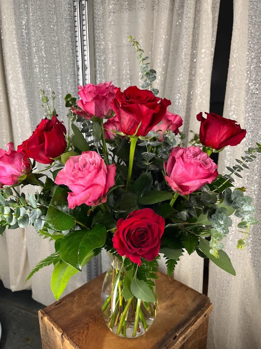 Red and Pink Dozen Roses - One dozen roses to include 6 red and 6 pink in a vase with filler and greens.  *Some stages of flower life may vary. (Example: Lilies may be more open than imaged.)  Flower shortages and product availability means that some substitutions will apply. Value will always be filled. This bouquet might include eucalyptus amongst the greenery. It may be toxic to pets including but not limited to Cats and Dogs if digested.