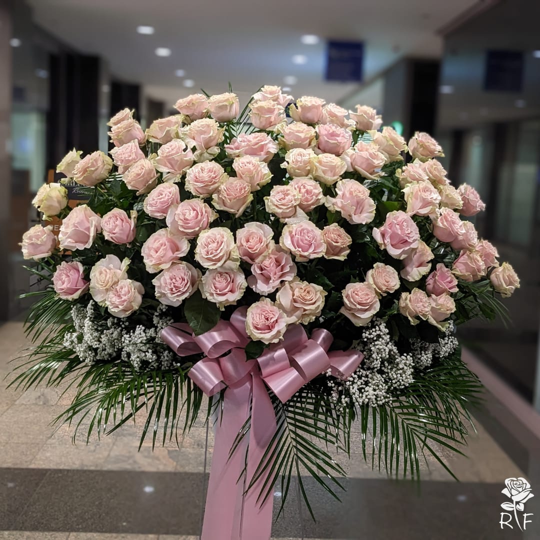 Five Dozen (60) Premium Light Pink Roses On A Stand - 60 beautiful long stemmed light pink roses arranged with premium greenery in white container on a stand.