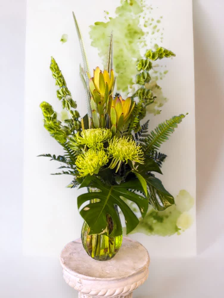 &quot;Nature&quot; from the Rainbow Collection by Art &amp; Flowers - Introducing &quot;Nature&quot; from the Rainbow Collection by Art &amp; Flowers—a striking all-green, tall, one-sided floral arrangement that captures the essence of the natural world. This elegant piece features a lush assortment of ferns, fancy greens, Bells of Ireland and green mums, meticulously arranged to create a sophisticated and refreshing display. Perfect for any occasion, &quot;Nature&quot; brings a touch of tranquility and vitality, making it the ideal choice for adding a natural elegance to your space. Let the vibrant greenery and refined design of &quot;Nature&quot; infuse your surroundings with its timeless beauty.