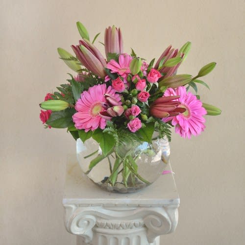 A Pink me Up - Pink Gerbera Daisy , Mini Spray Roses, Tulips and Lilies in a bubble bowl