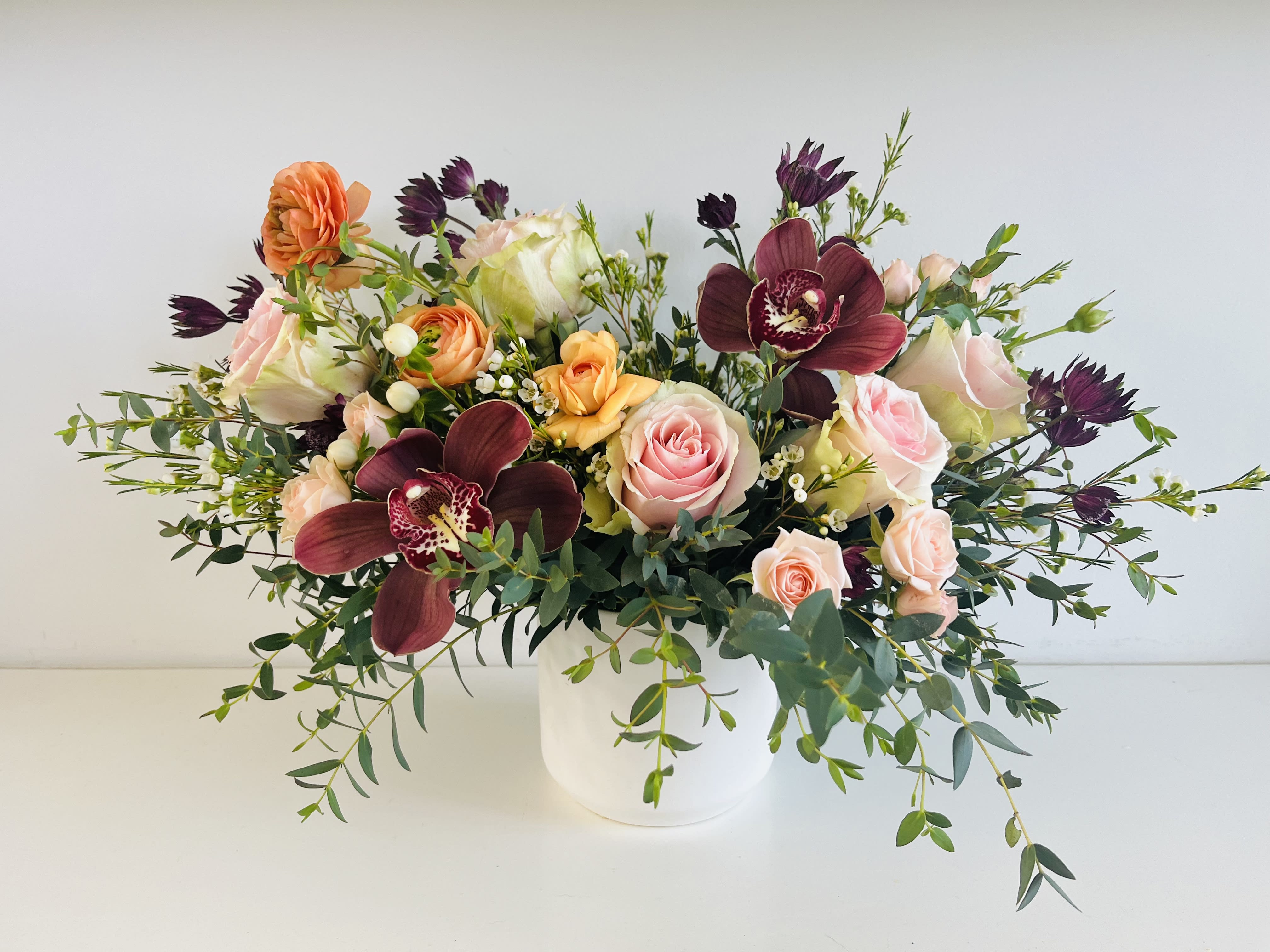 Blooms - Pinks and rich burgundy's of in season flowers make up this beautiful design
