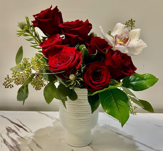 One of a Kind  - One of a Kind pairs bold red roses with a single white orchid, adding elegance and flair. The orchid’s color and variety may vary based on availability, making each arrangement unique and memorable.