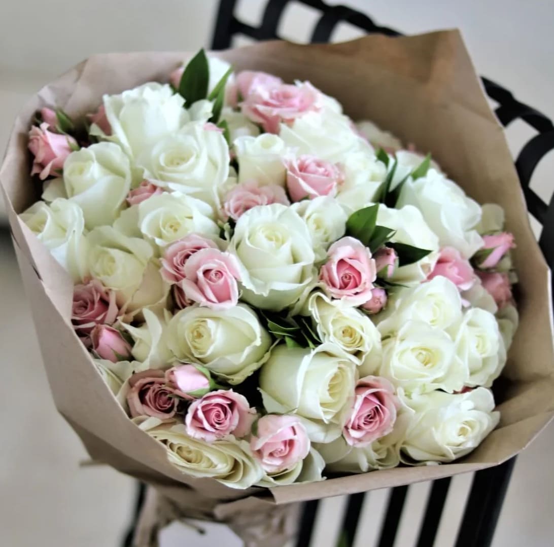 50 roses - Fifty beautiful roses delicately wrapped in craft paper. Perfect gift for a birthday or as a thank you. Handwritten card is included. Send the most beautiful flowers for that special someone. Next day delivery available to Tequesta, Jupiter, Palm Beach Gardens and Palm Beach. NO VASE INCLUDED  At checkout please indicate in florist instructions what you prefer for the main color of the florals.