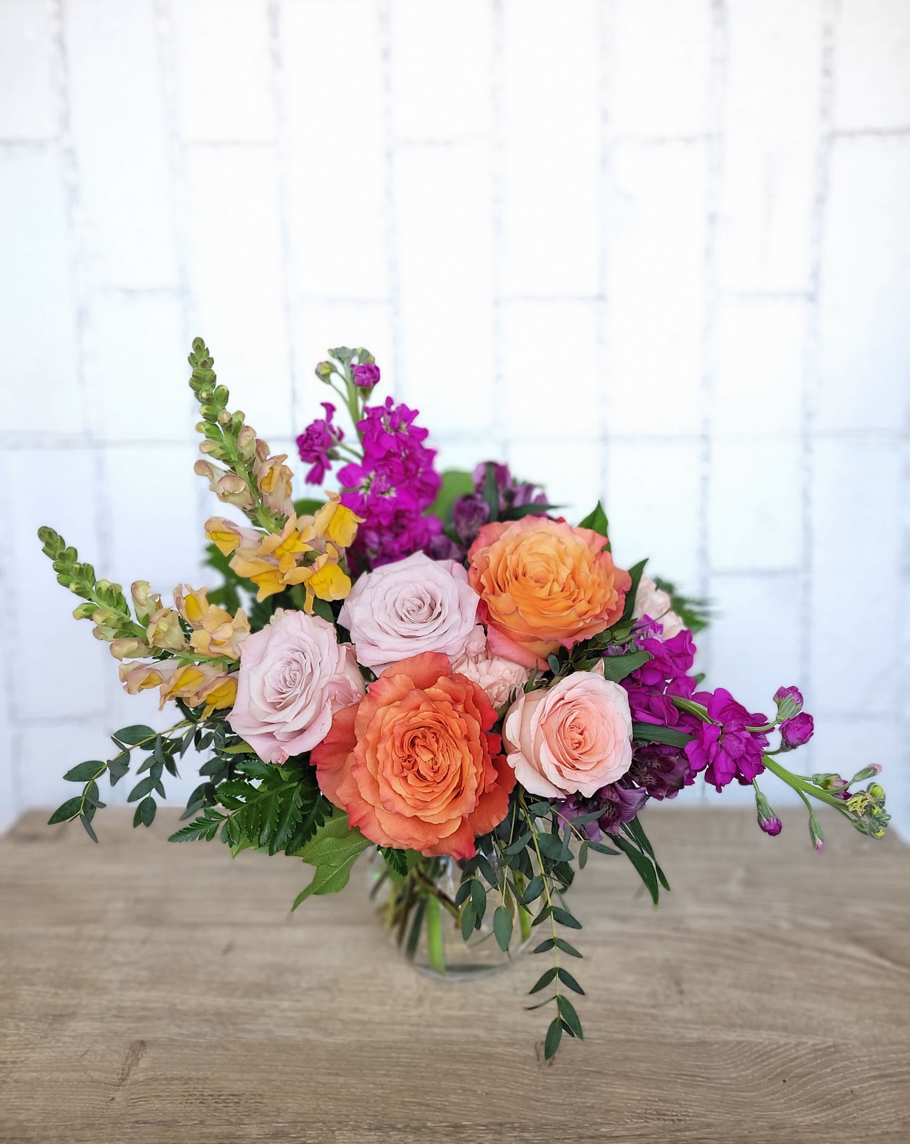 Daydreamer - For those who find inspiration in soft, colorful florals, and featuring a medley of roses and snapdragons, this arrangement conjures dreams of joyful afternoons spent watching the clouds float by through the sky. 