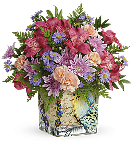 Teleflora's Sophisticated Whimsy Bouquet - High-flying style for Mother's Day! Surprise her on her special day with the whimsical charm of this vintage-inspired butterfly vase bursting with bright blooms.